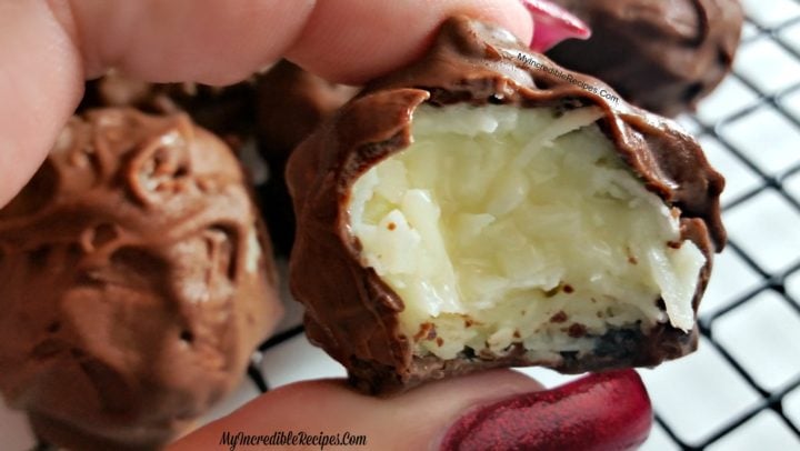 hand holding up a bitten Mounds Coconut Copycat Chocolate Ball
