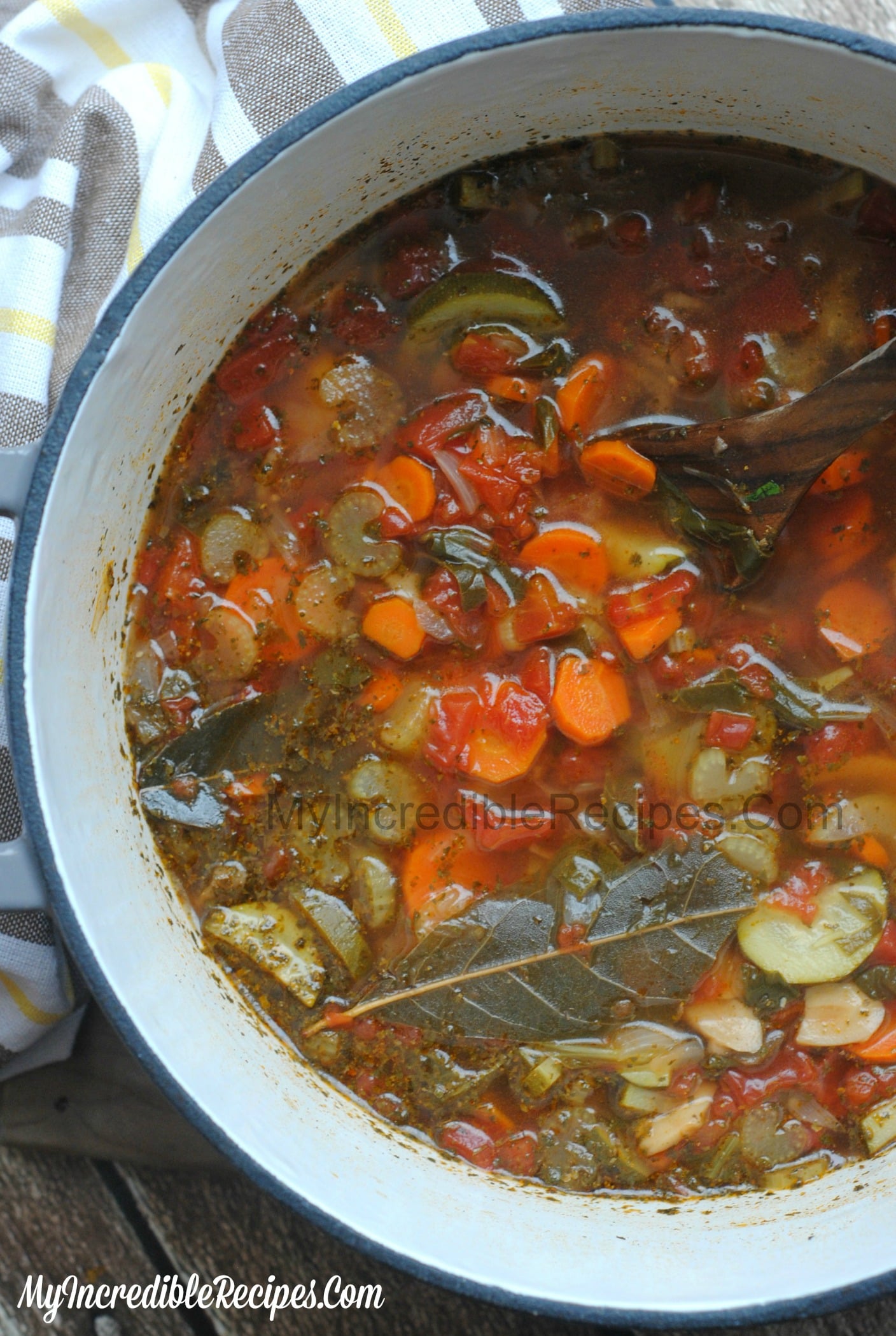 overhead shot of the Weight loss soup in a red dutch oven pot on a dark wood table 