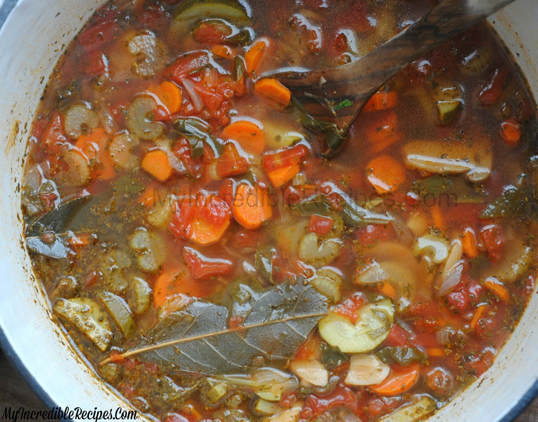 close up shot of the Weight loss soup in a red dutch oven pot on a dark wood table 
