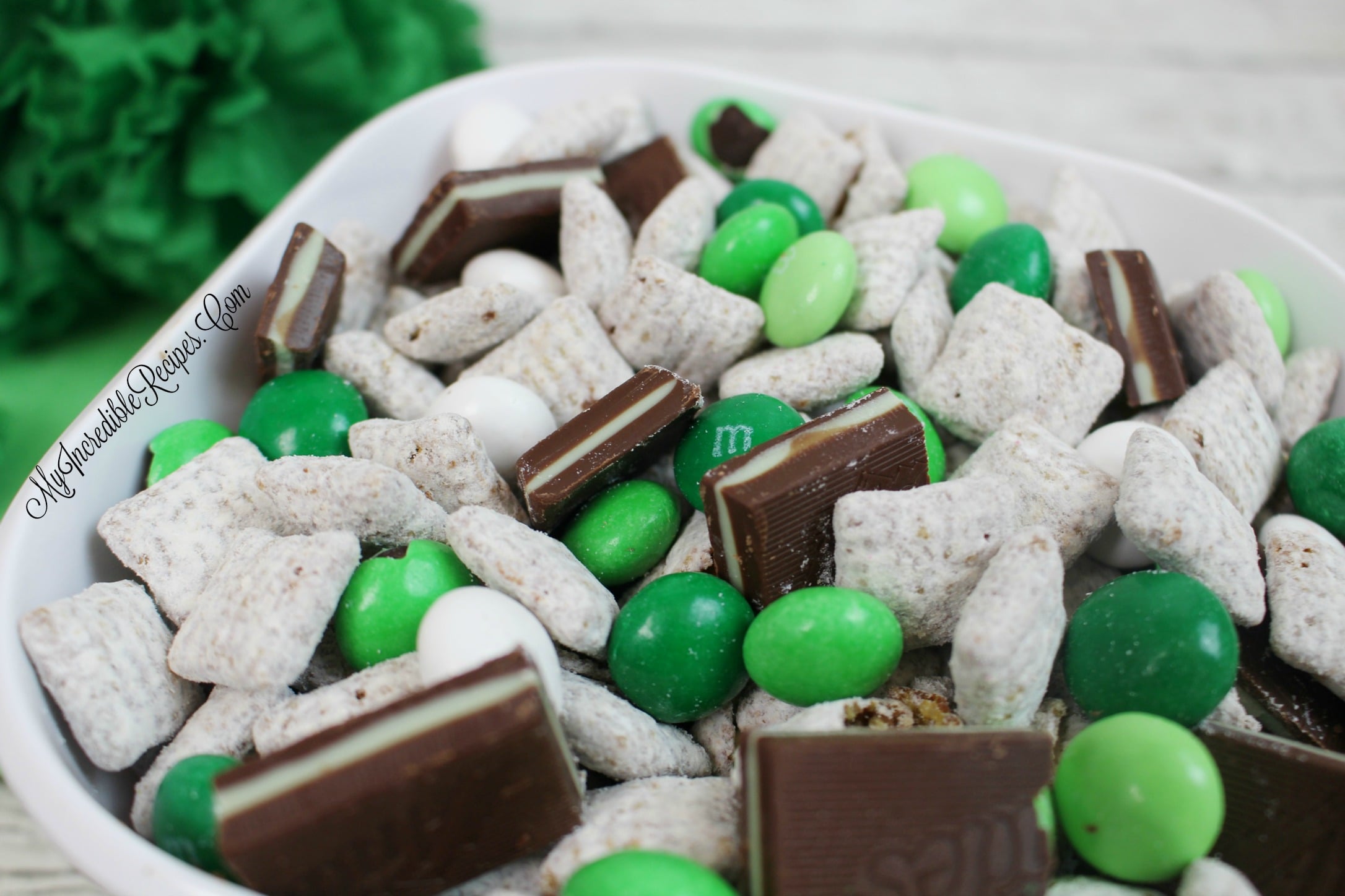 up close shot of Andes Mint Muddy Buddies in a pretty white bowl on a whitewashed wood table