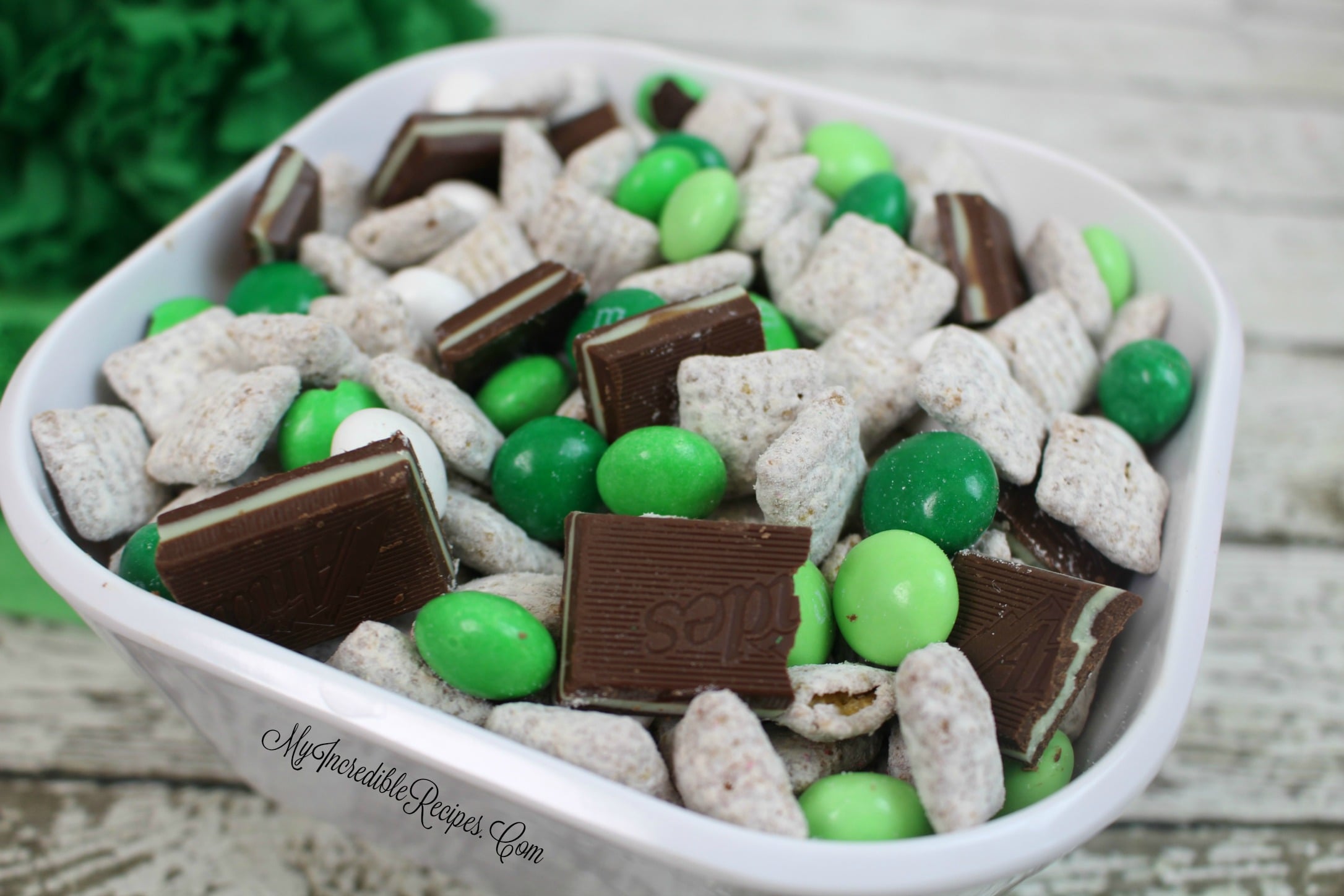 Andes Mint Muddy Buddies in a pretty white bowl on a whitewashed wood table