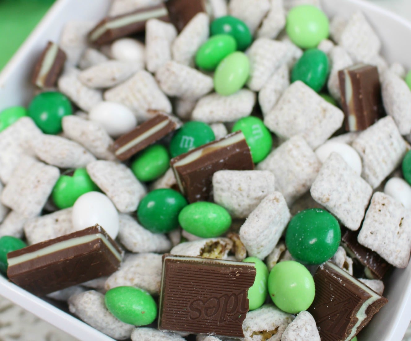 Andes Mint Muddy Buddies in a pretty white bowl on a whitewashed wood table