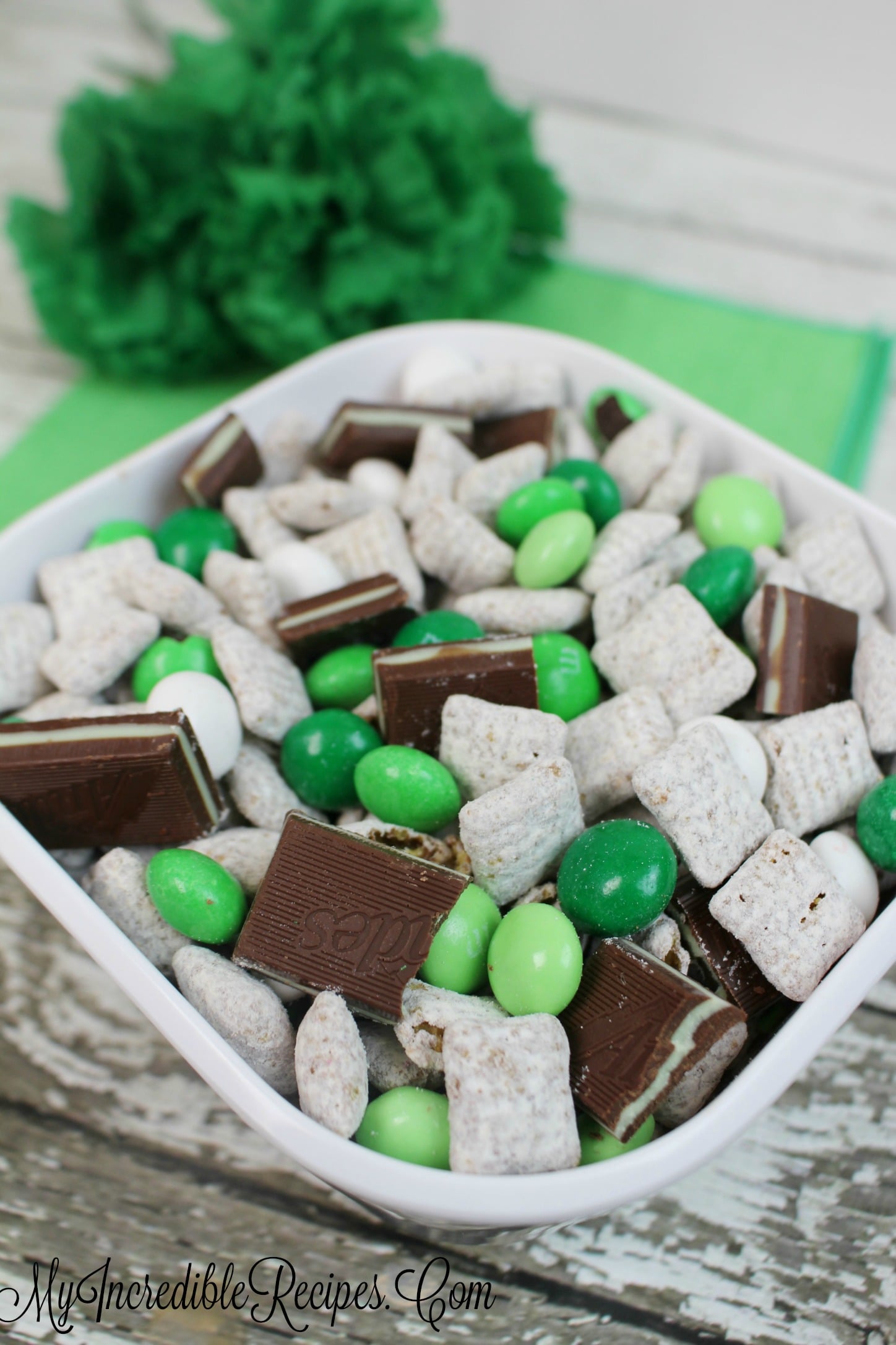 side view of the Andes Mint Muddy Buddies in a pretty white bowl on a whitewashed wood table