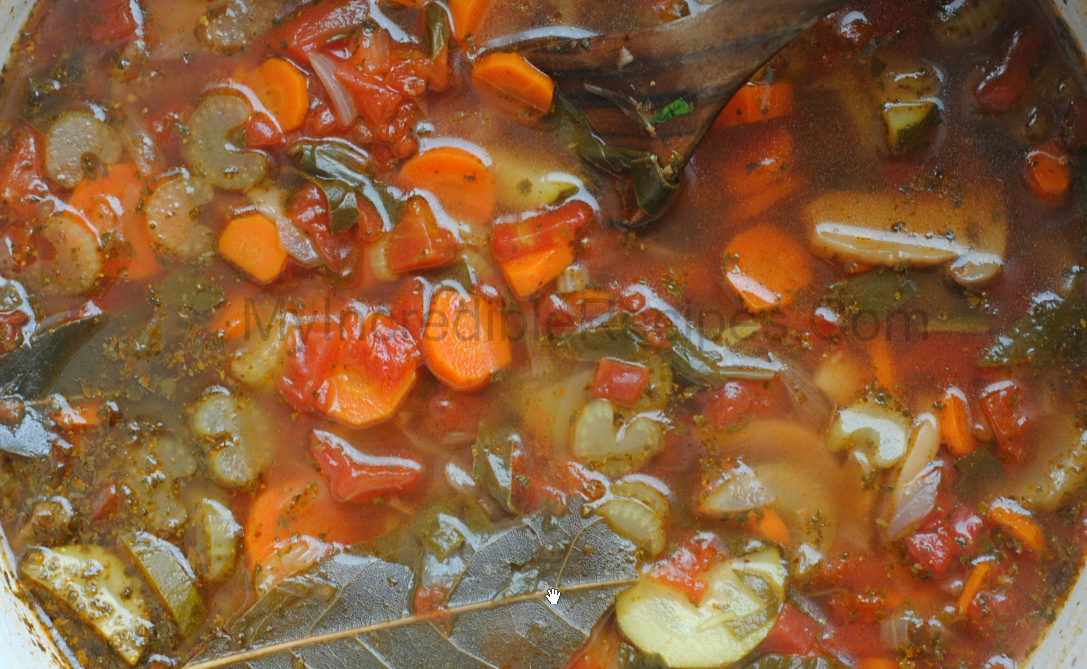 up close shot of Weight loss soup in a red dutch oven pot on a dark wood table 