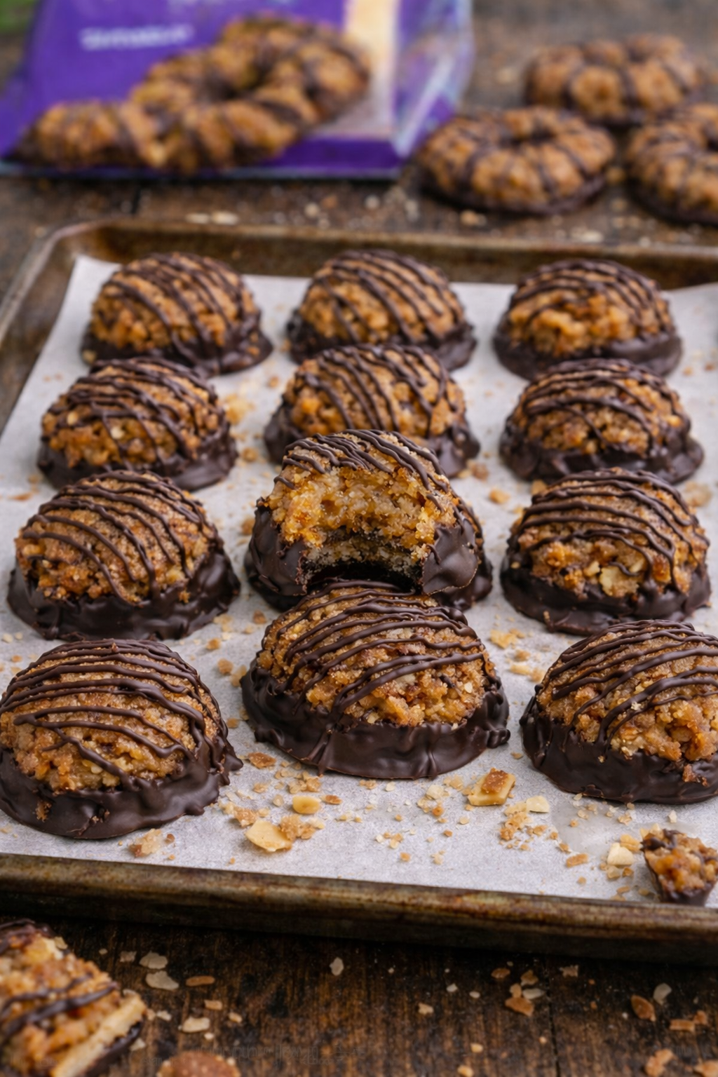 Samoa Bites on a parchment paper lined baking sheet drizzled with chocolate