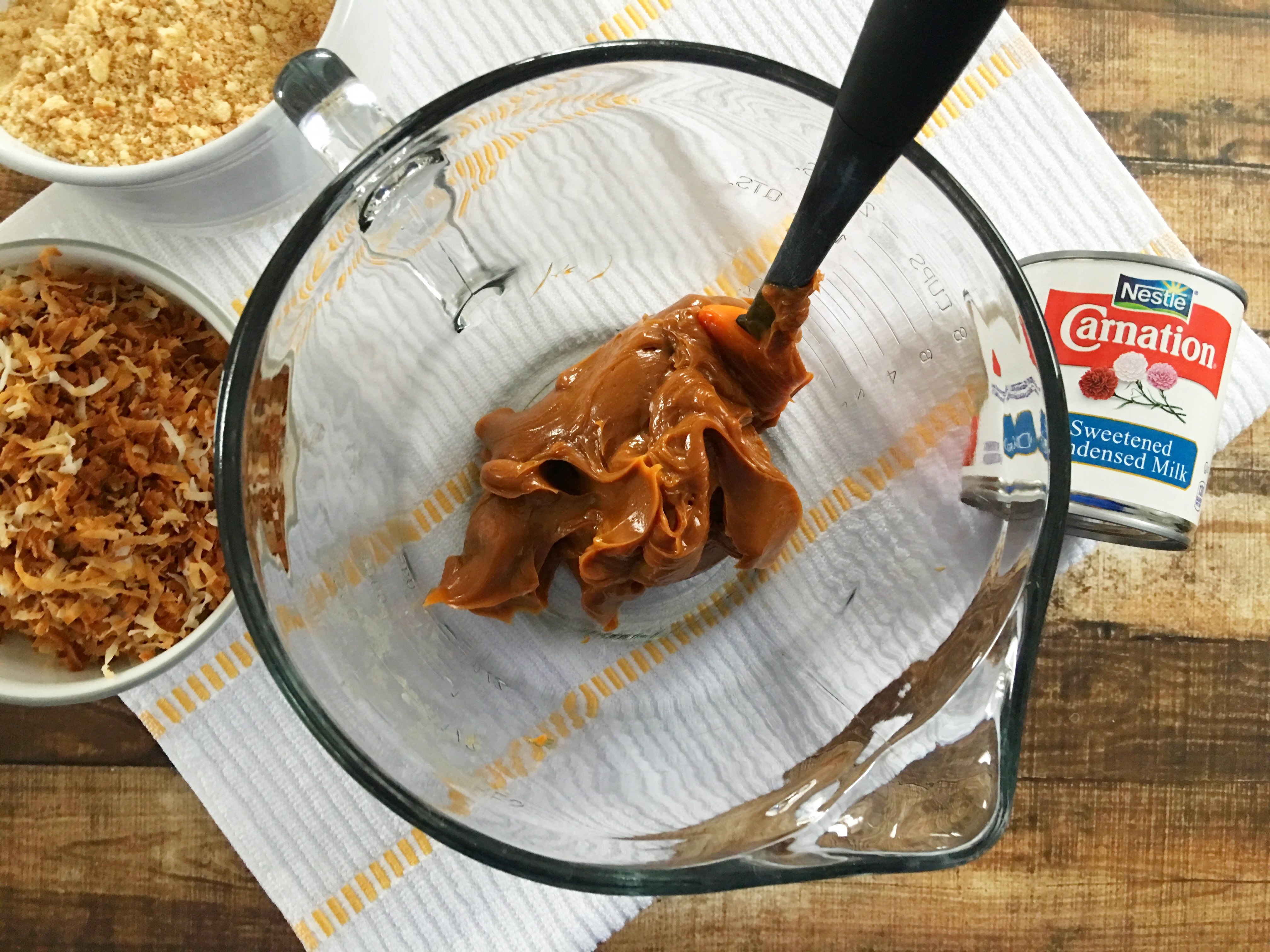 Samoa Bites being mixed in a mixing bowl with caramel