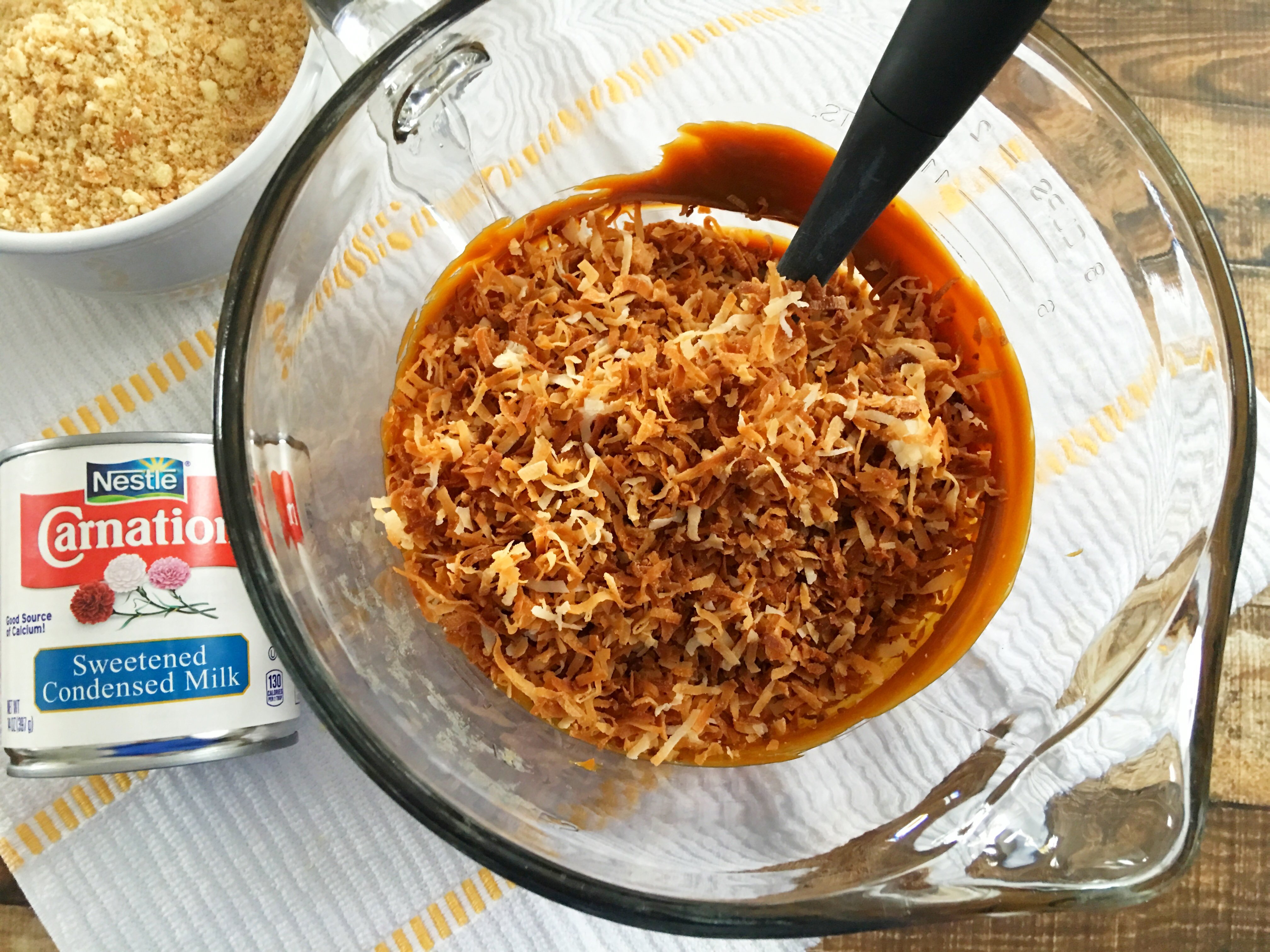 Samoa Bites being mixed in a mixing bowl with coconut