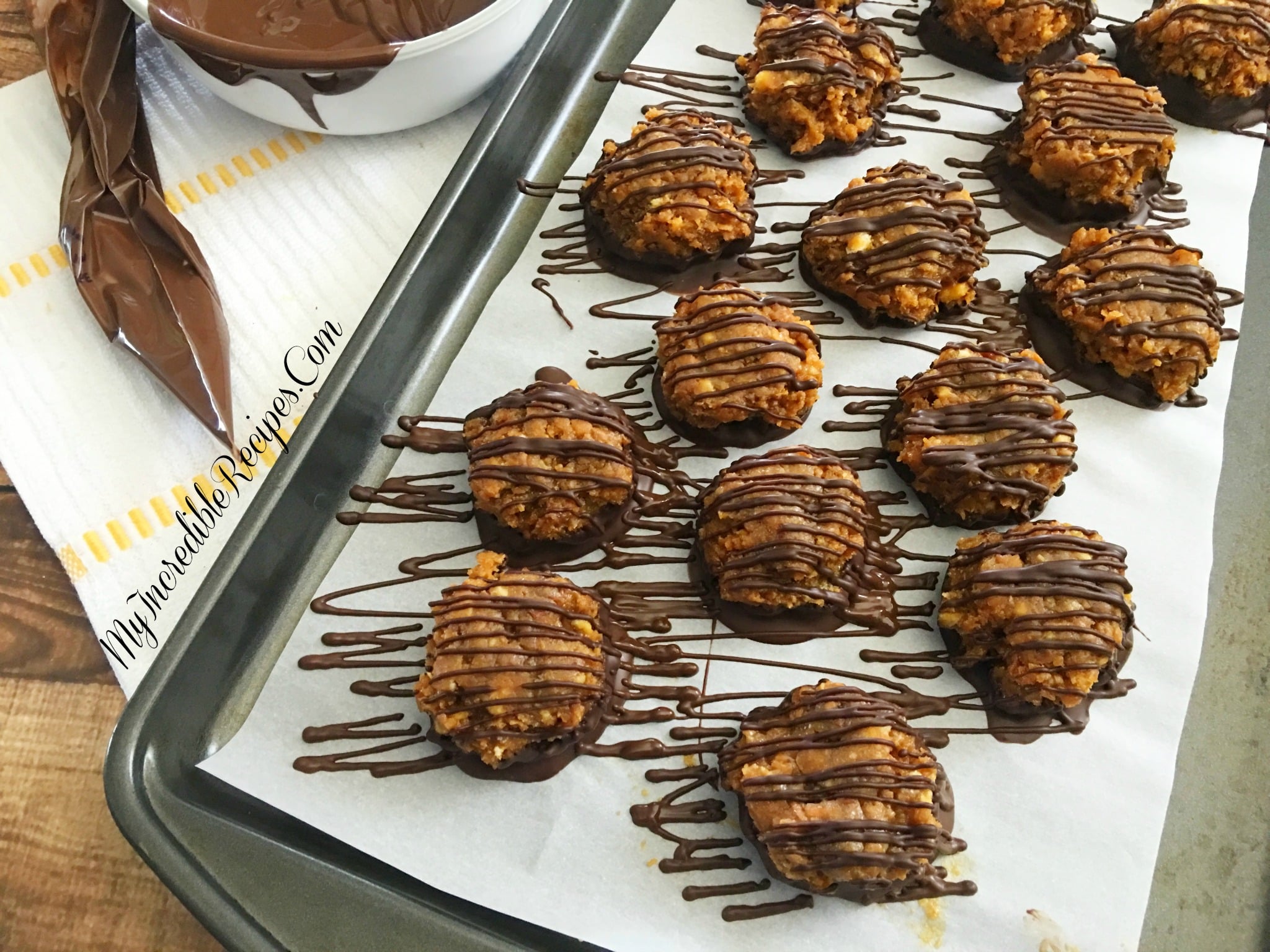 Samoa Bites on a parchment paper lined baking sheet drizzled with chocolate