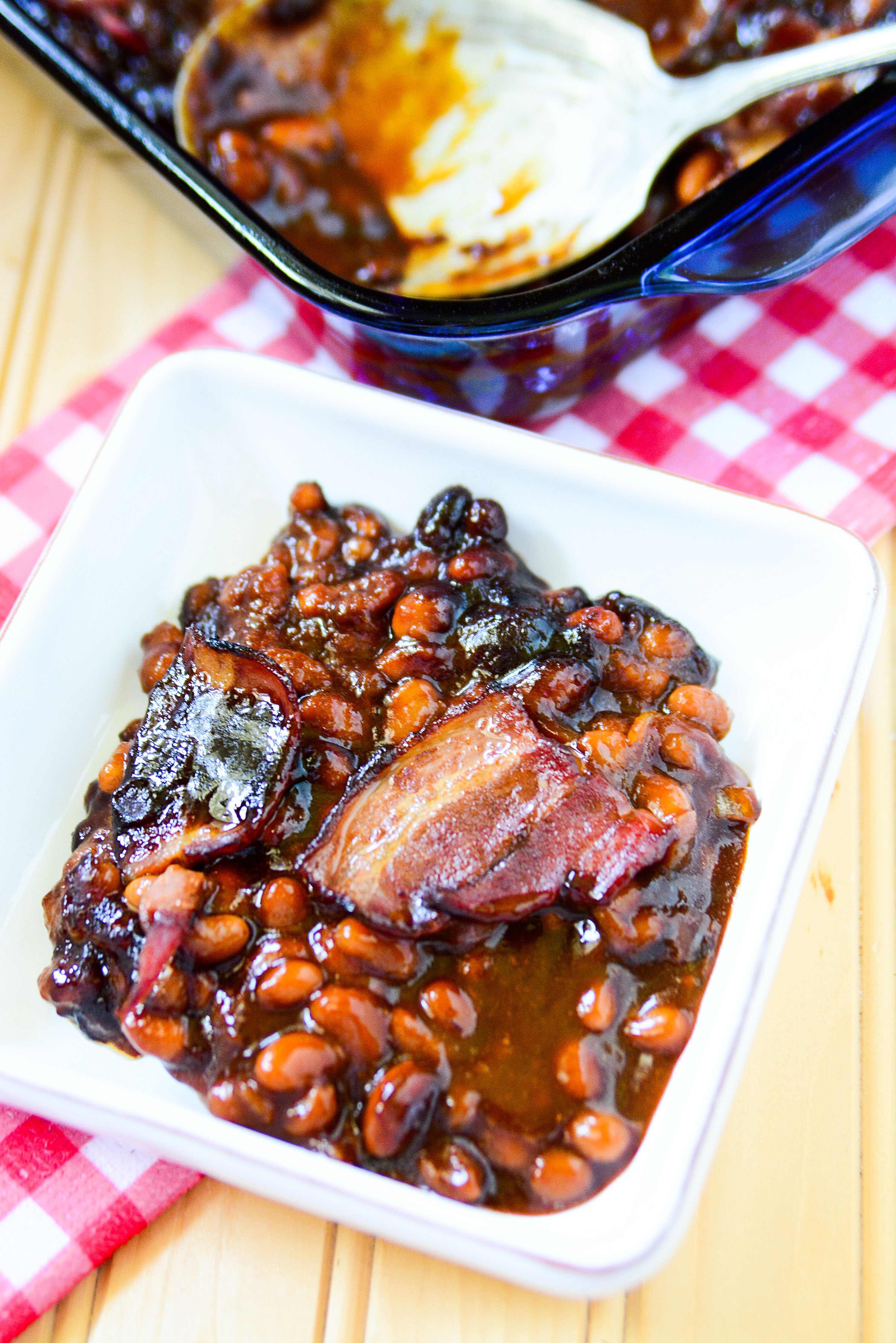 Brown Sugar Bacon Baked Beans in a white bowl up close