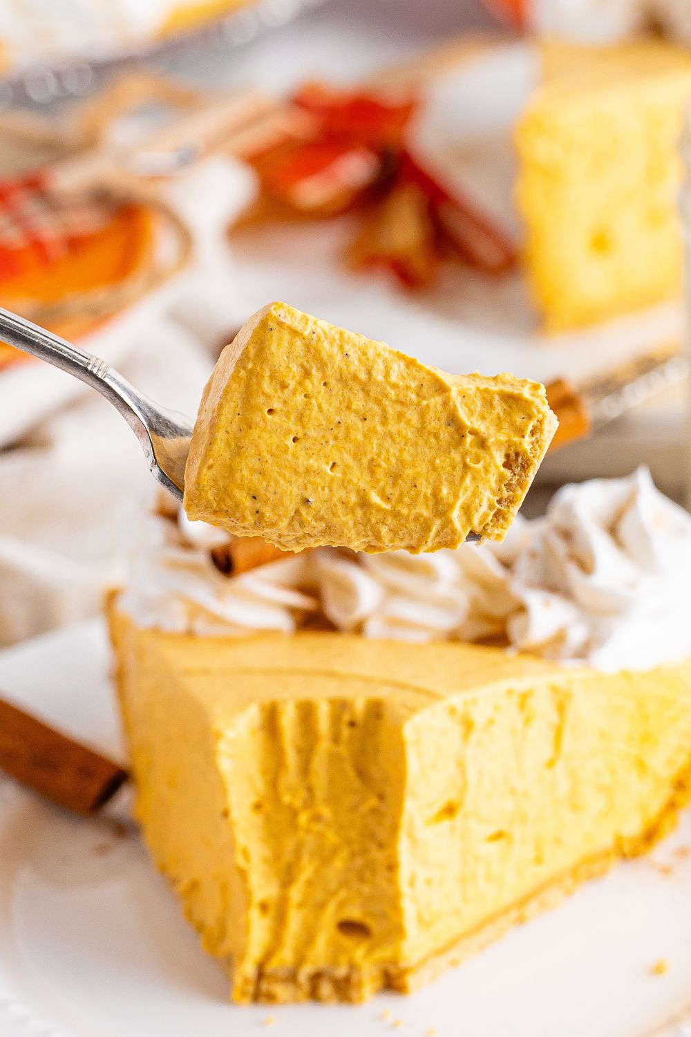 slice taken out of pumpkin cheesecake on plate