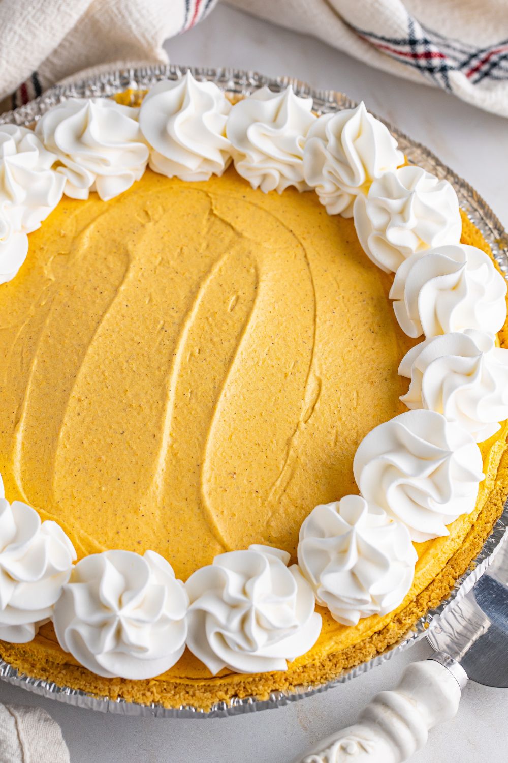 overhead view of pumpkin cheesecake in a pan on table