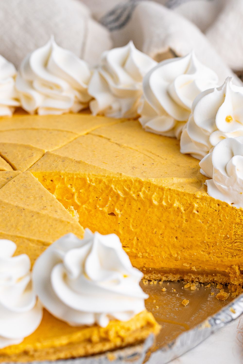 No Bake Pumpkin Cheesecake with a slice taken out of the cheesecake 