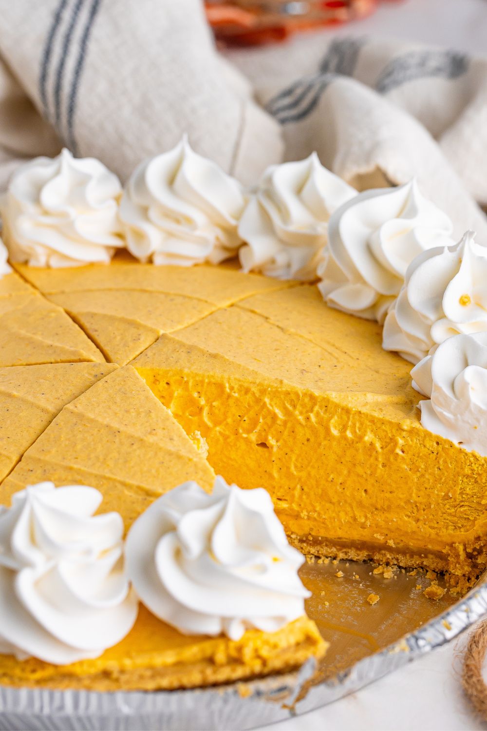 pumpkin spice cheesecake with slice taken out of pan