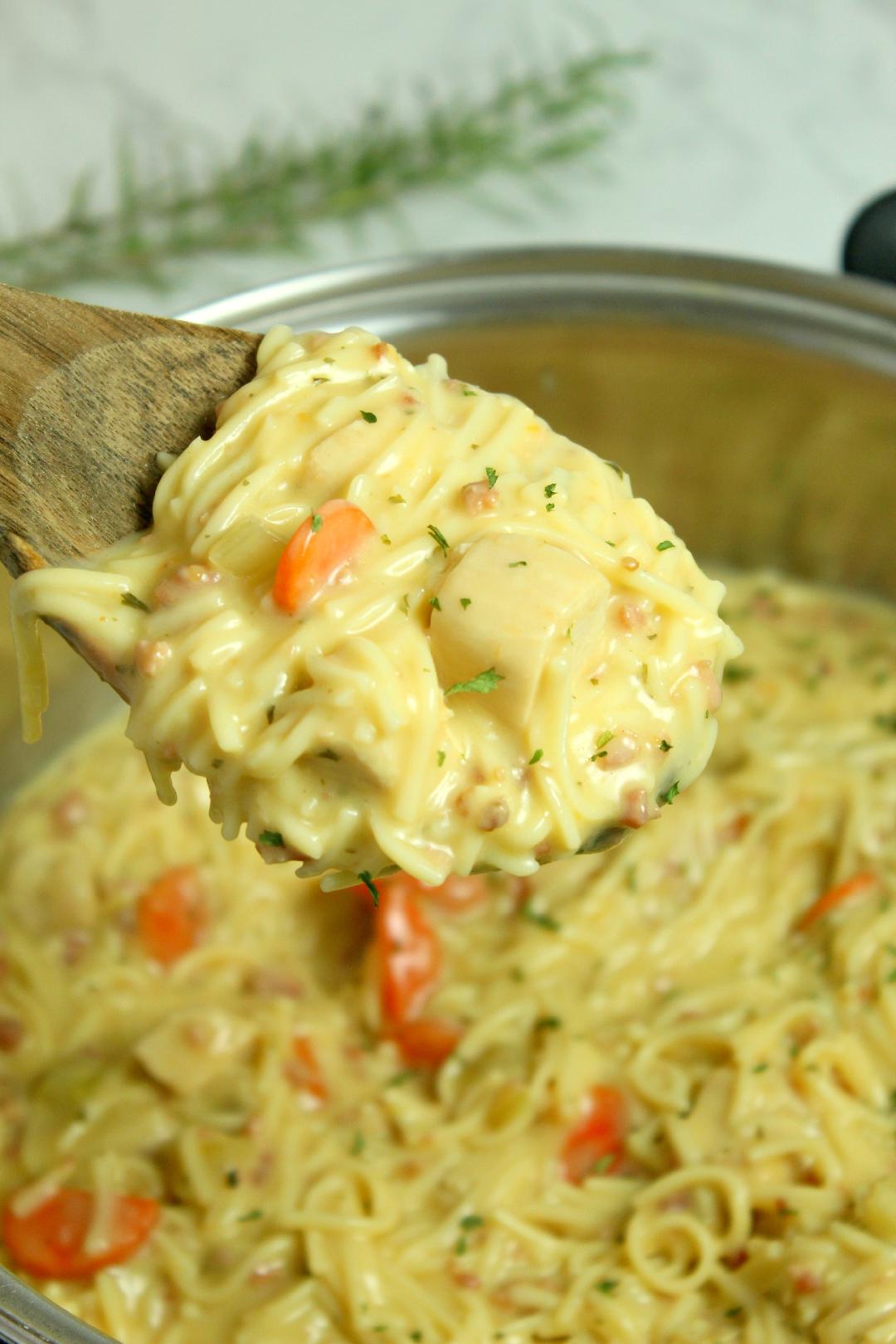 Crack Chicken Noodle Soup being lifted by a wooden spoon