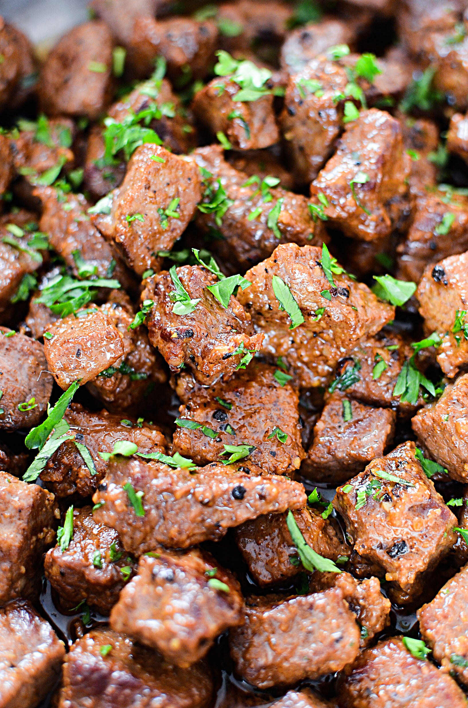 up close shot of Juicy Garlic Butter Steak Bites on a pretty white plate