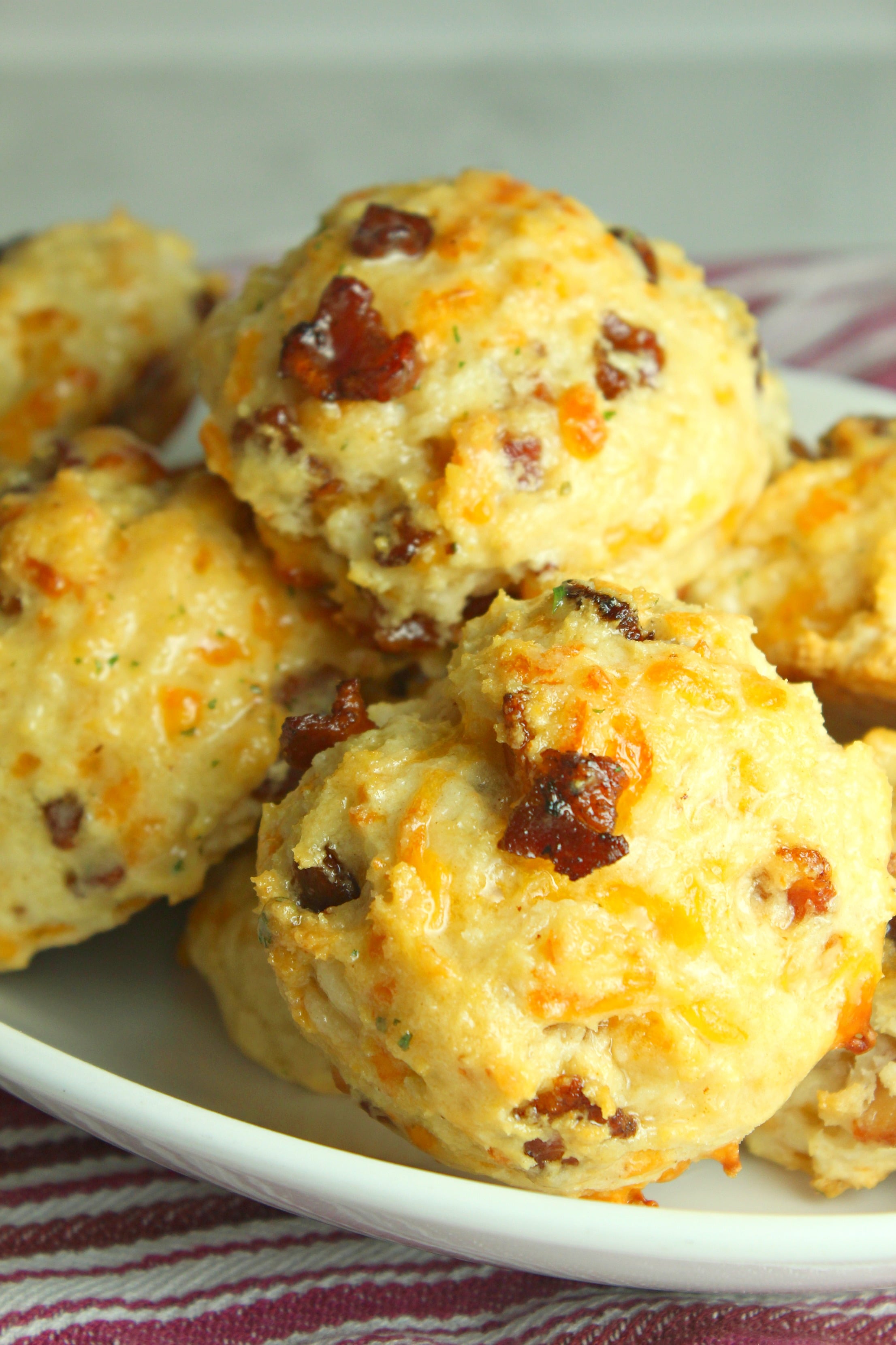 Cheesy Bacon Garlic Biscuits on a pretty white plate on a table