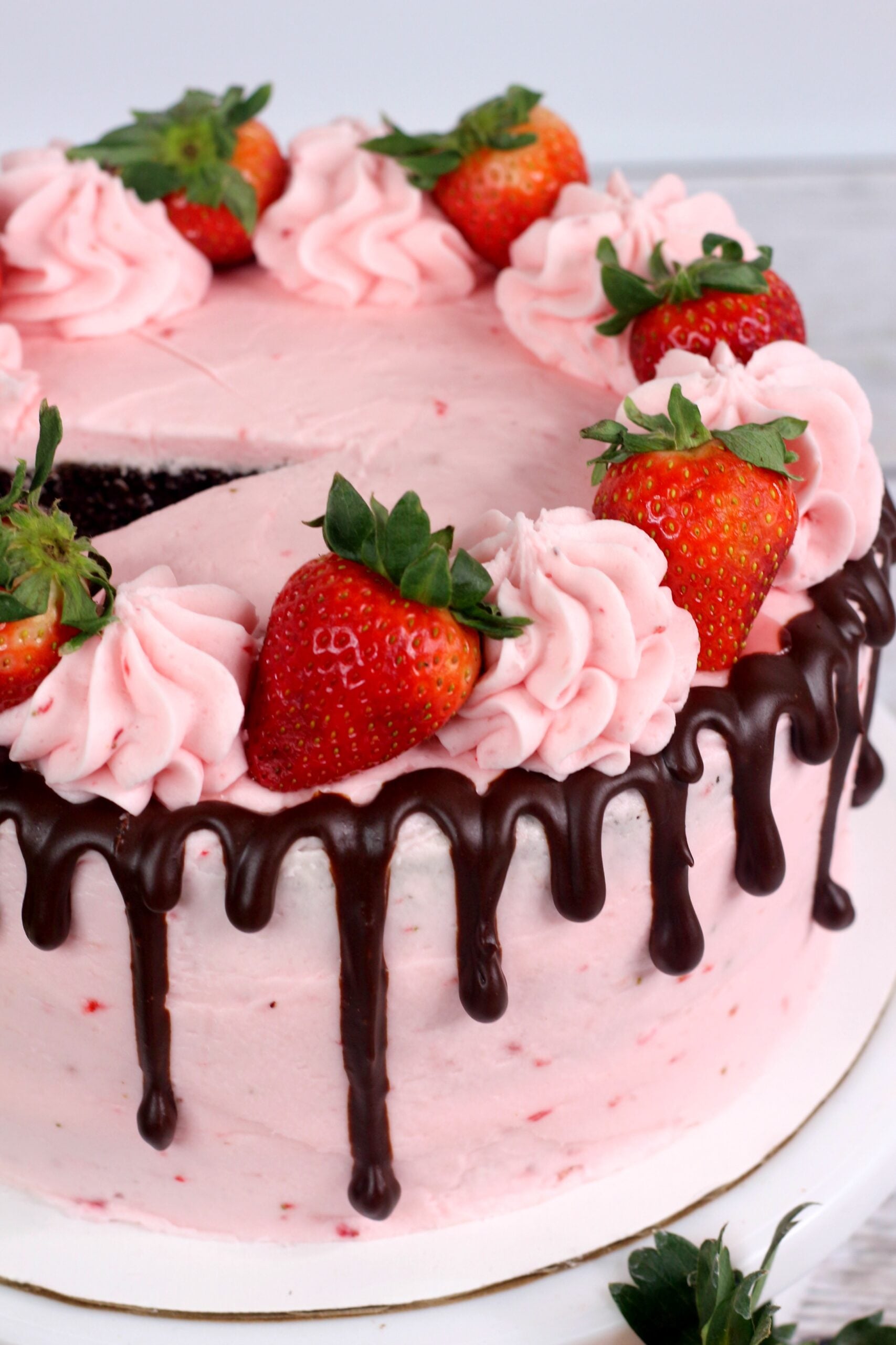Chocolate Kahlua Cake with Strawberry Buttercream Frosting on a white cake dish