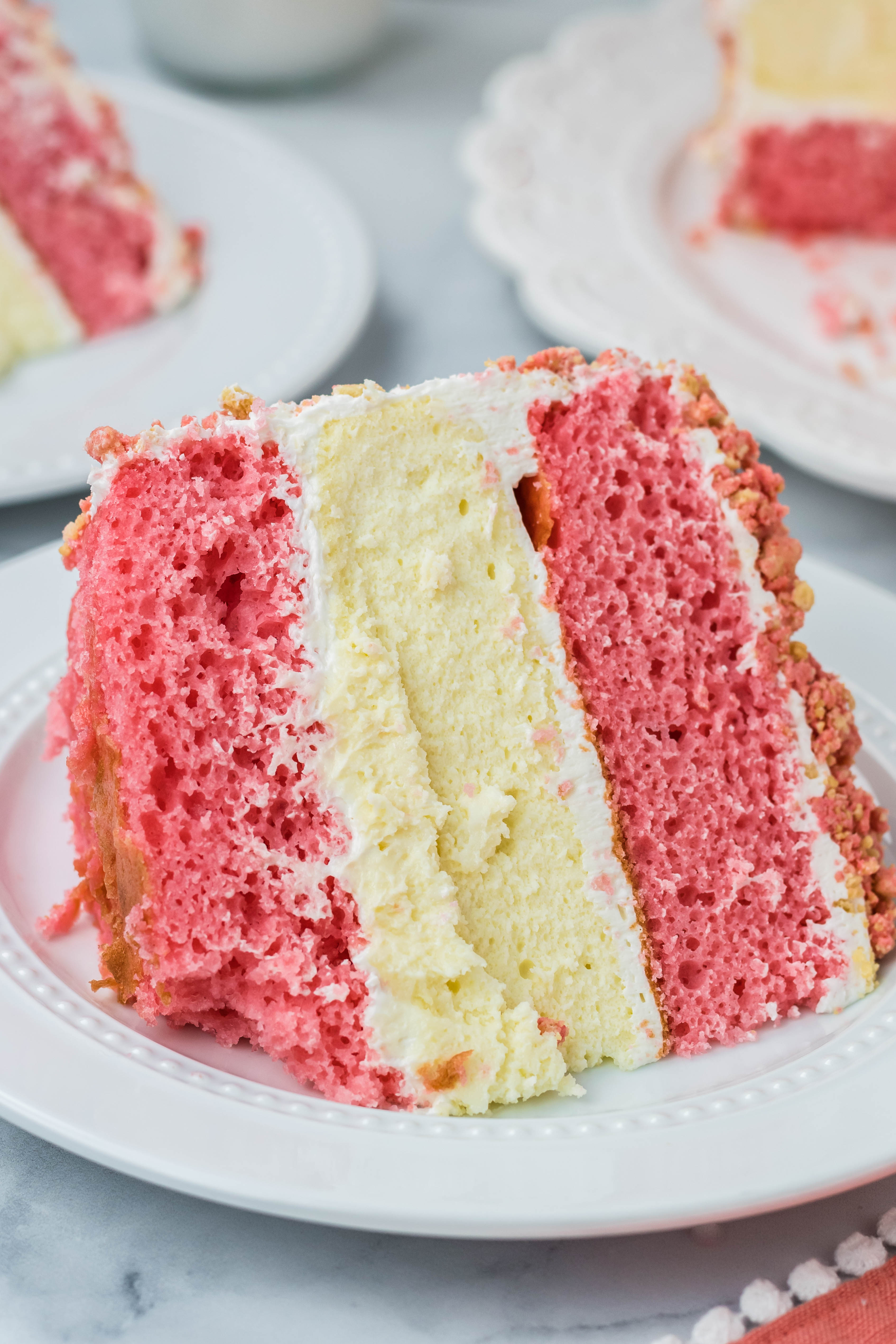 Strawberry Shortcake Cheesecake Cake slice on a white plate