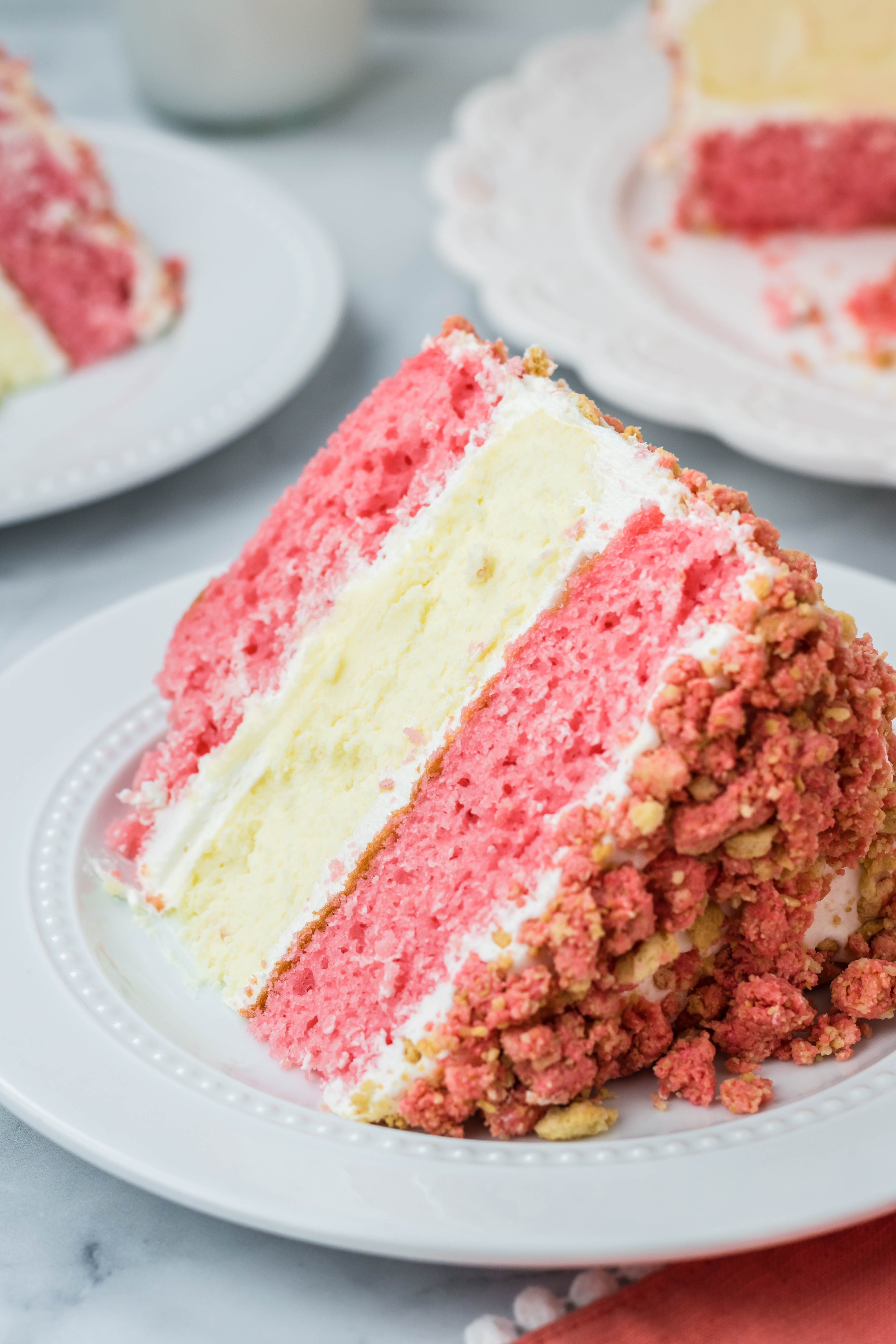 slide angle shot of the Strawberry Shortcake Cheesecake Cake on a white plate