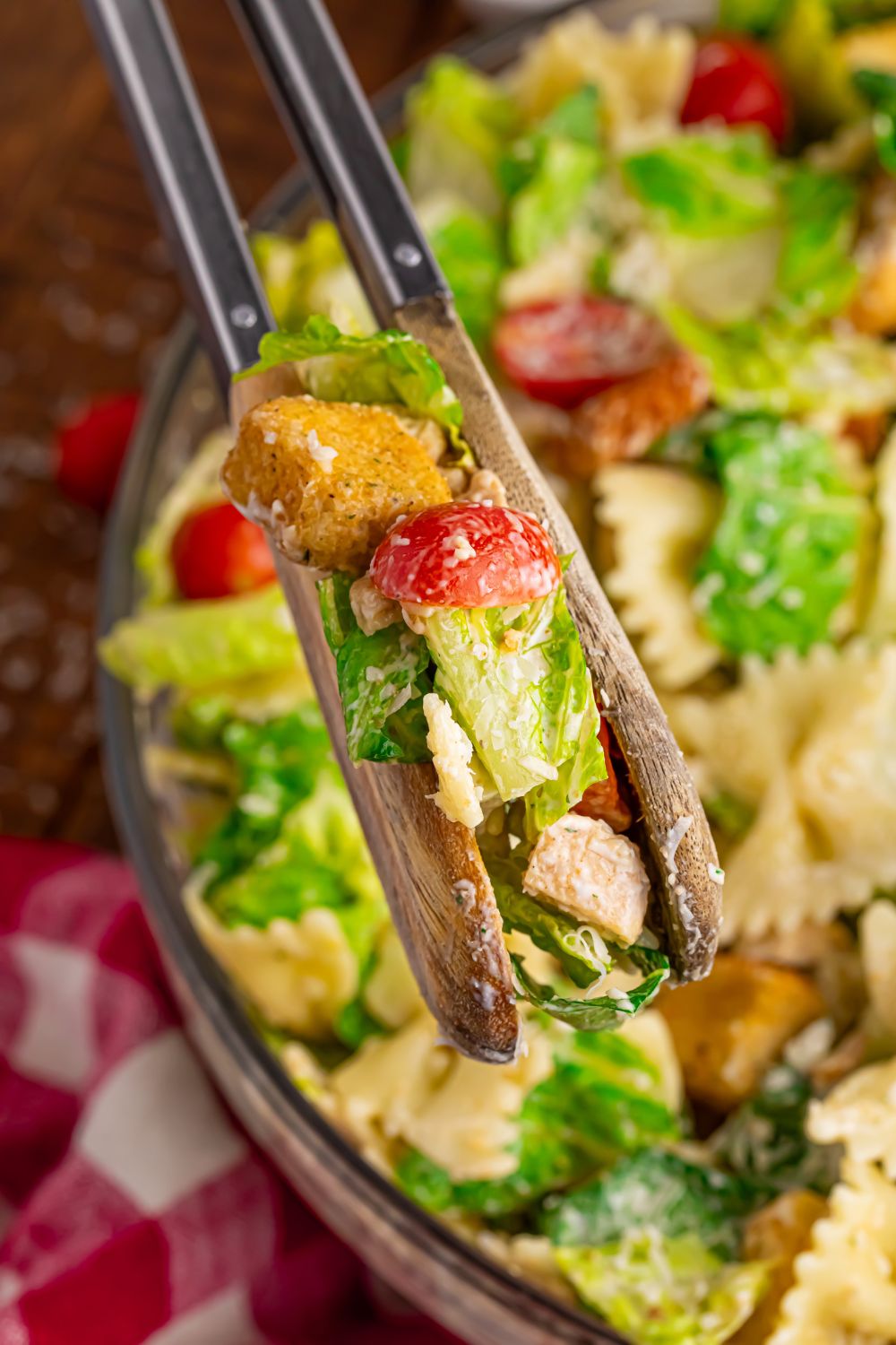 Caesar pasta salad being lifted out of the bowl 