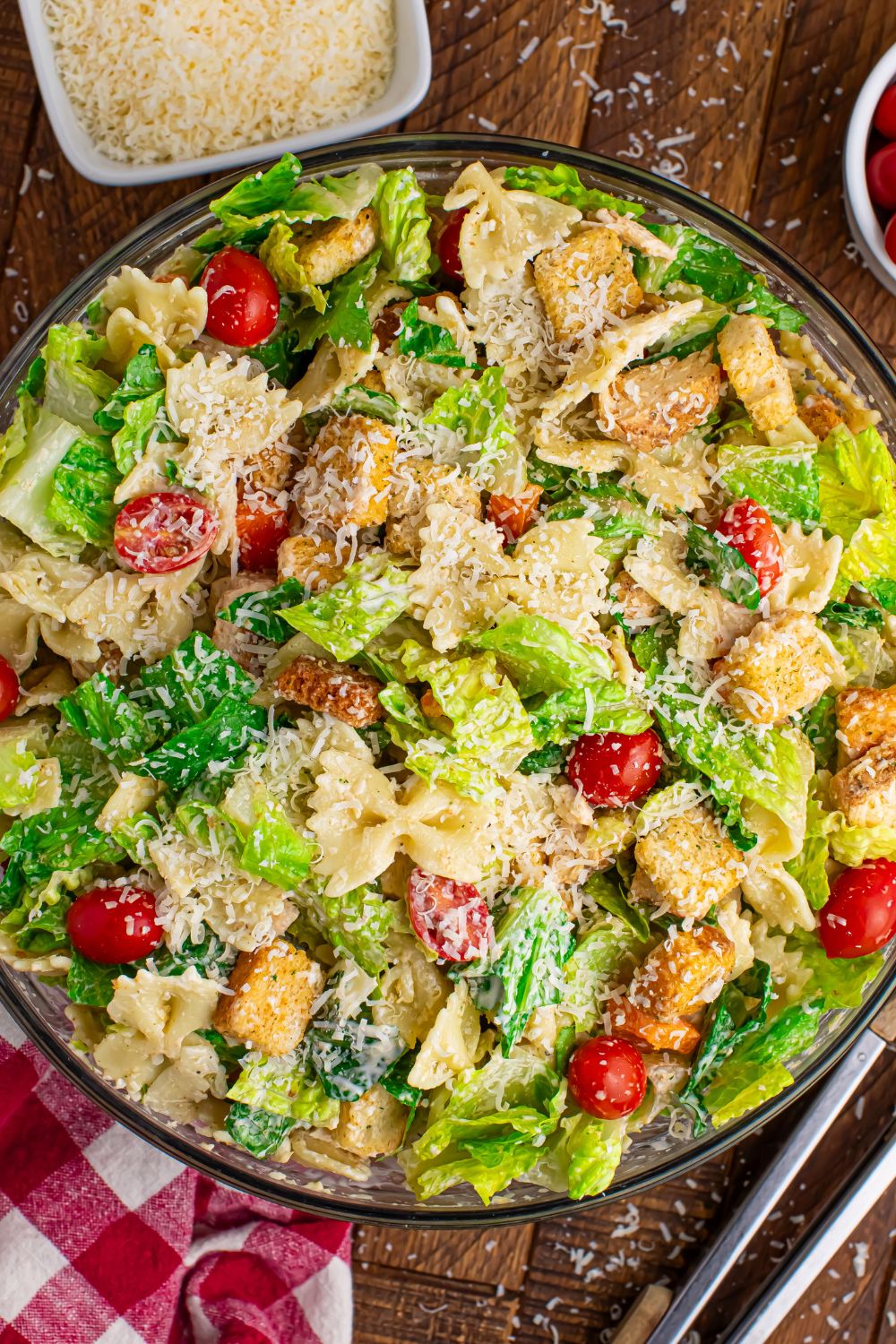 Chicken Caesar Pasta Salad in a bowl with grated parmesan cheese in a bowl 