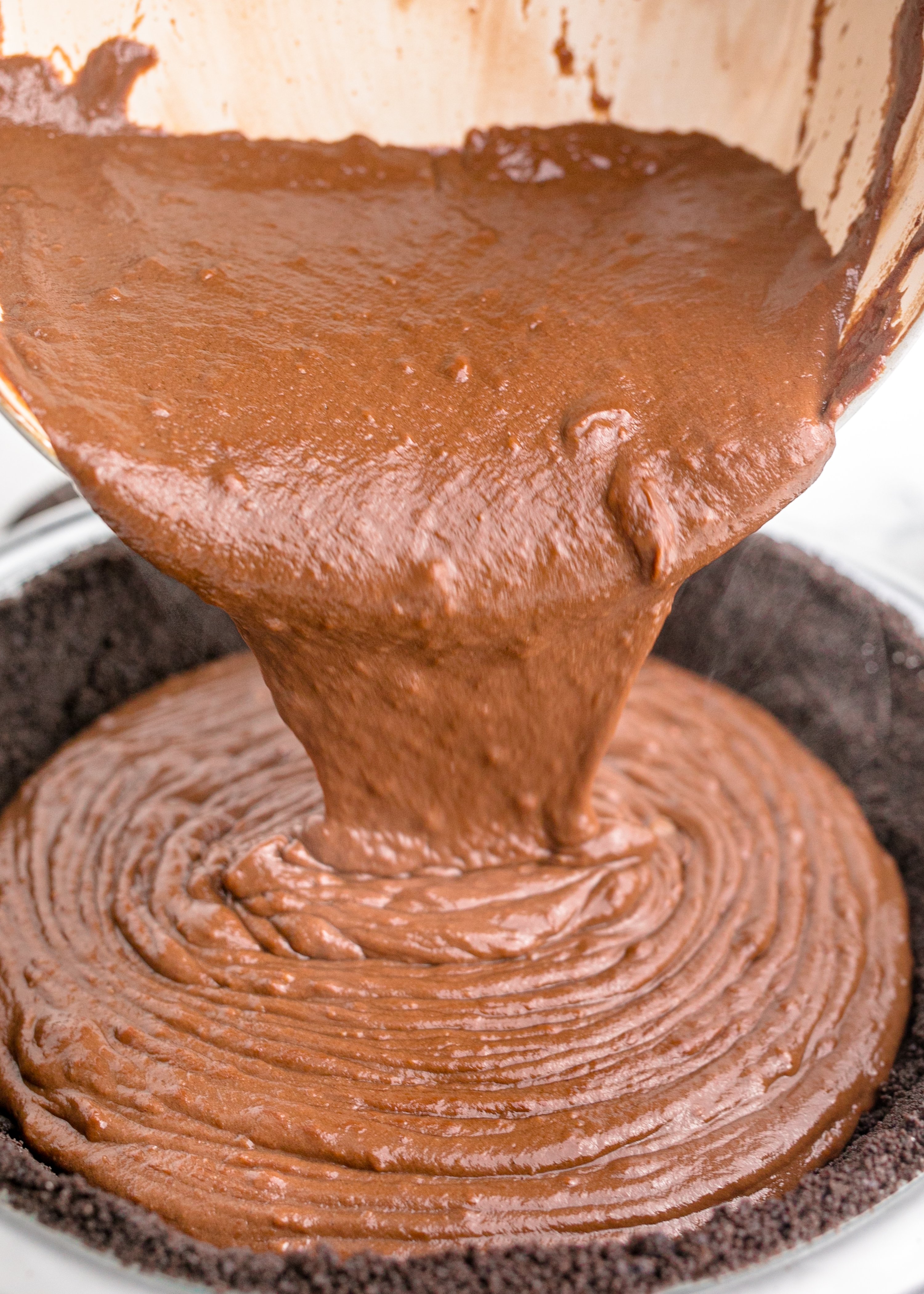 Chocolate Cream Pie being poured into a oreo crust