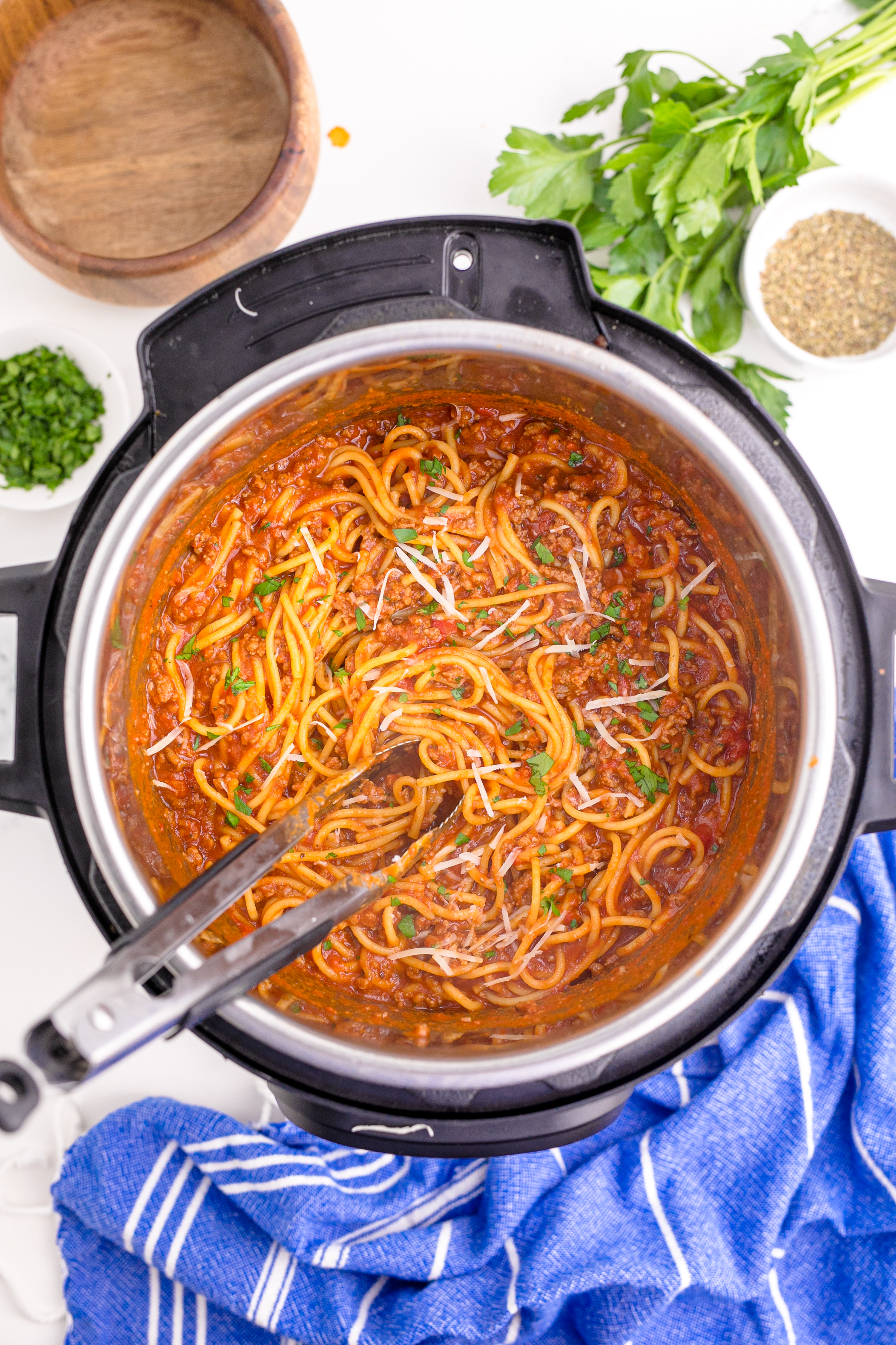 Instant Pot Spaghetti inthe instant pot being mixed with tongs over head shot