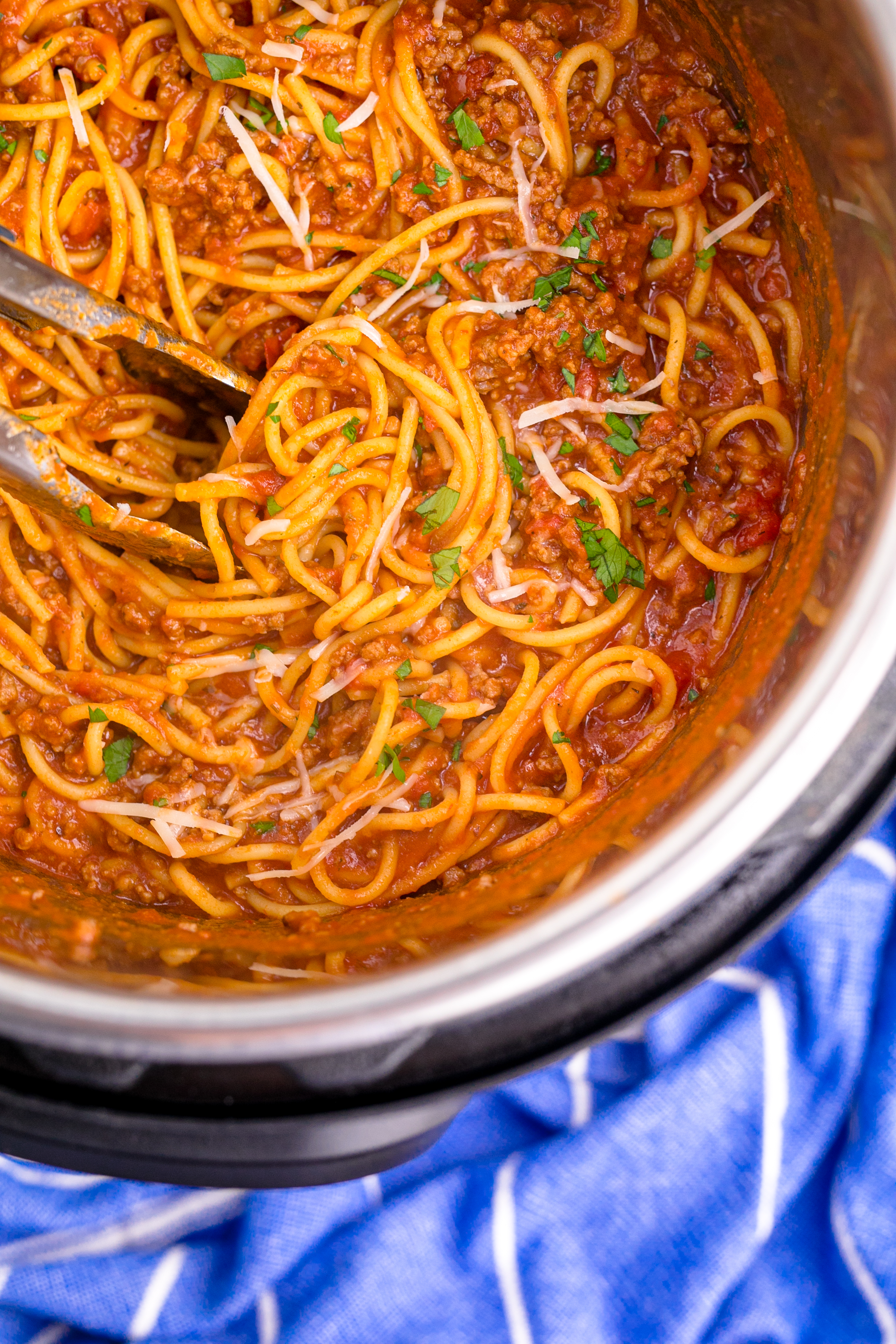 Instant Pot Spaghetti inthe instant pot being mixed with tongs overhead shot