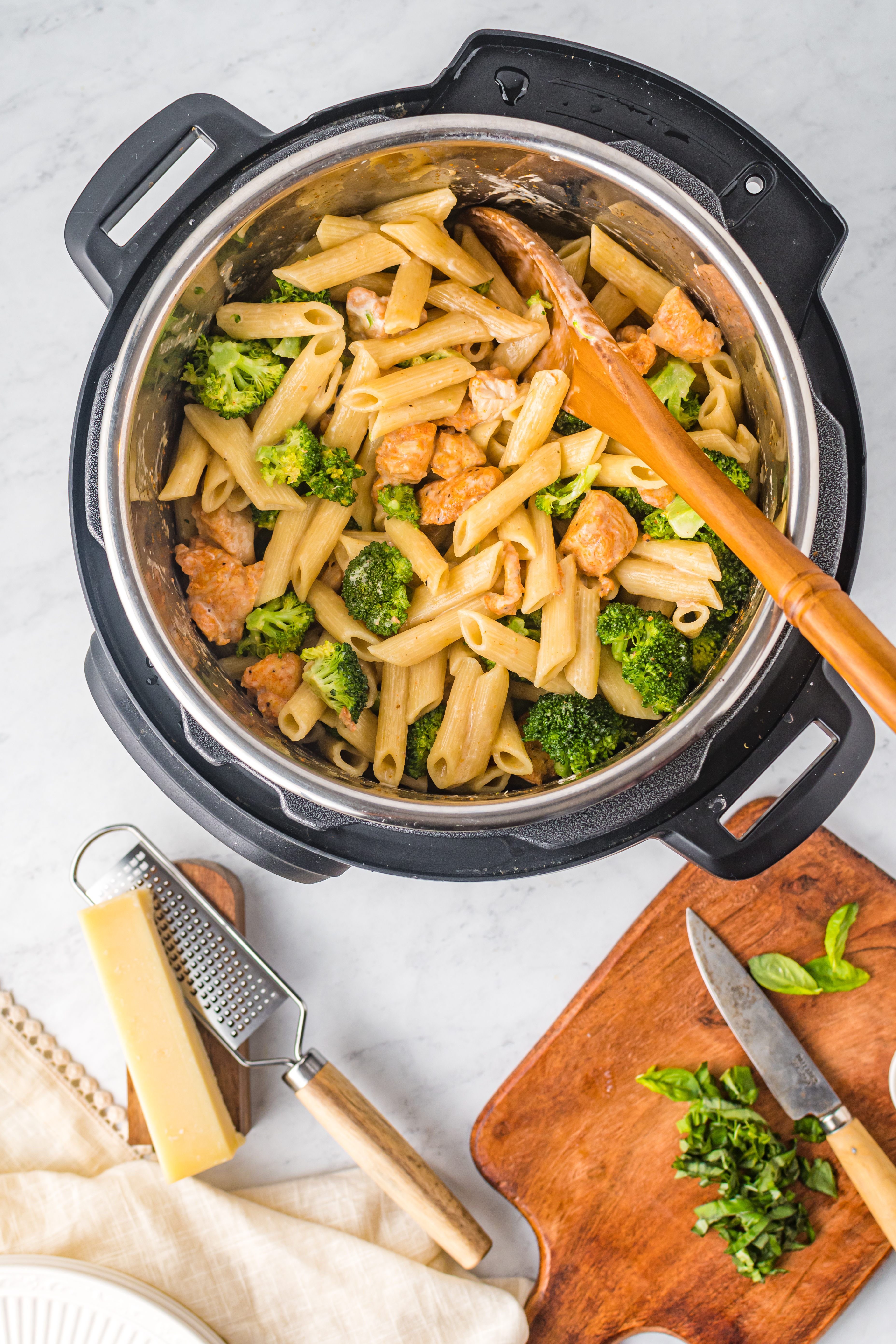 Chicken Pasta in a pot covered in cheese mixed with broccoli