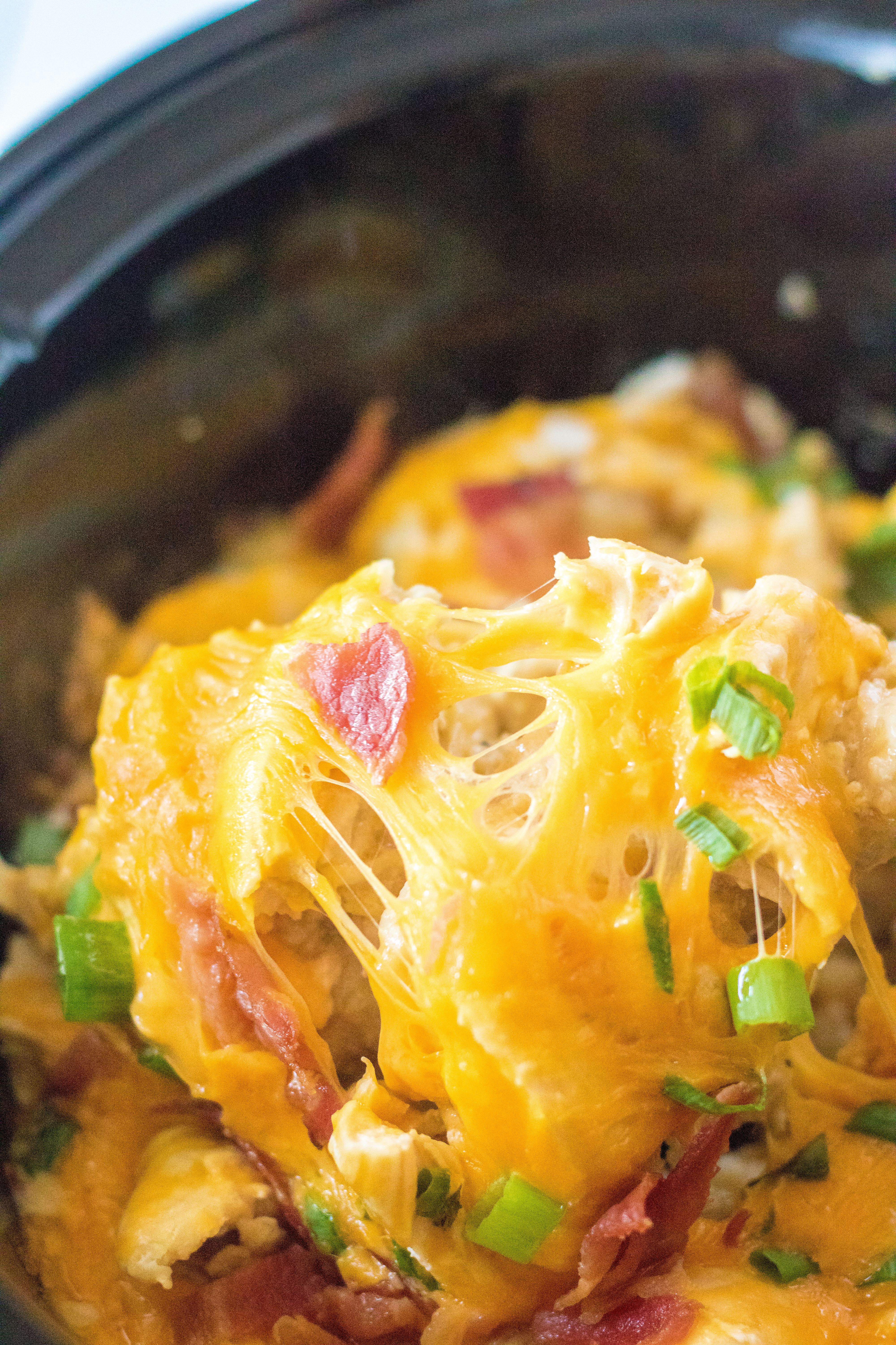 Tater Tot Casserole in the crock pot on a spoon