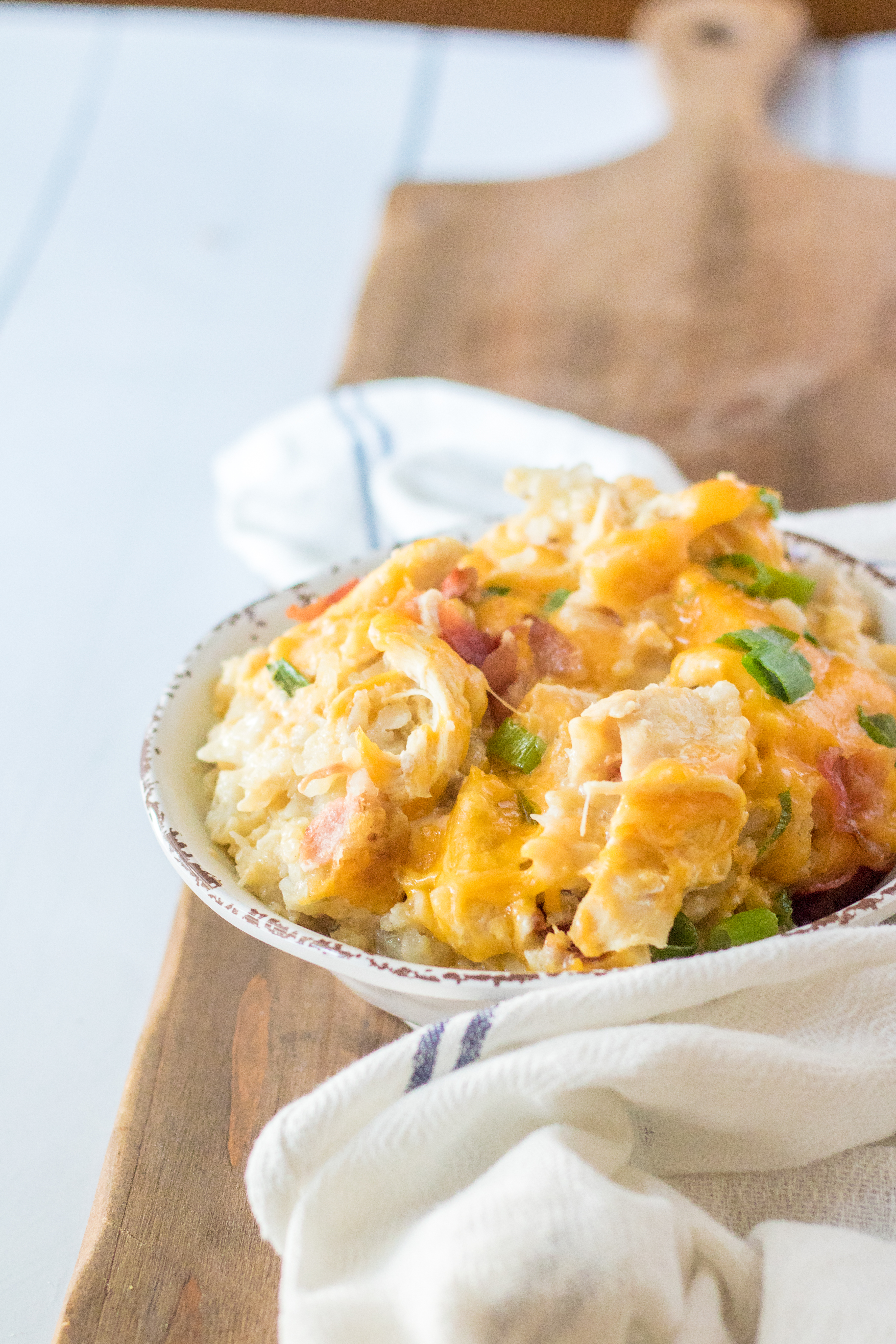 Tater Tot Casserole in a white bowl from the side