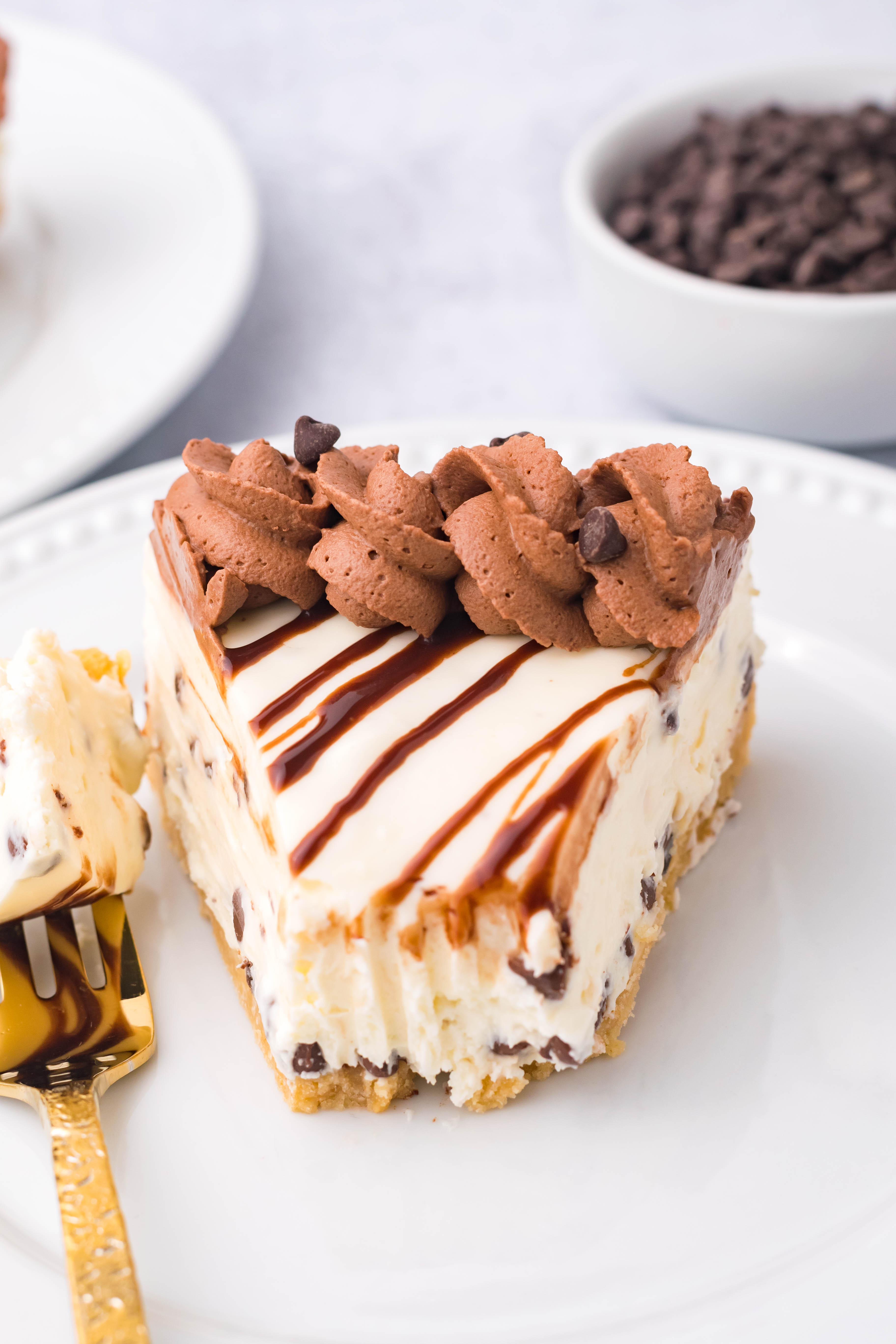 Chocolate Chip Cheesecake on a white plate with a bite taken out overhead angle