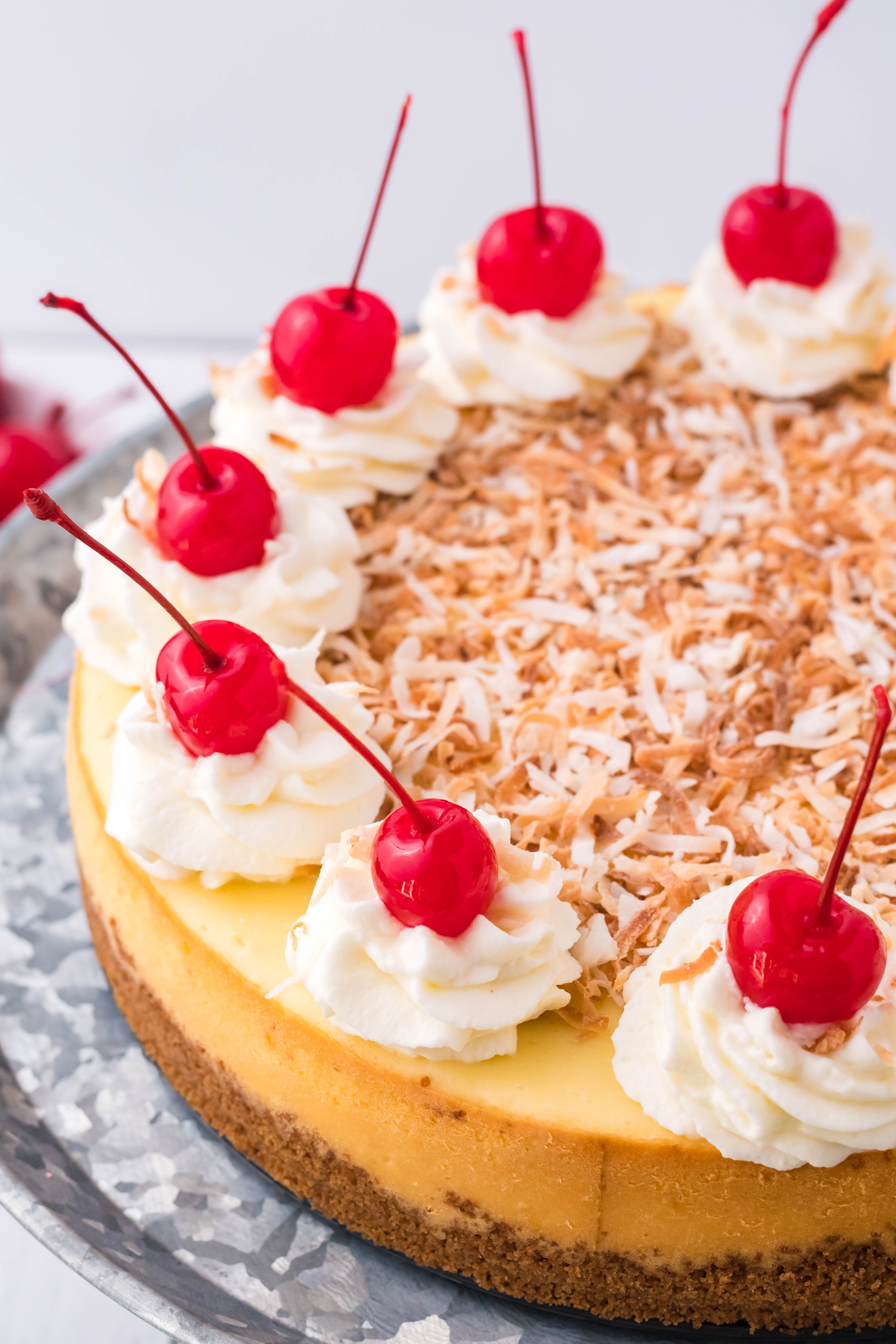 Coconut Cheesecake on a silver cake dish