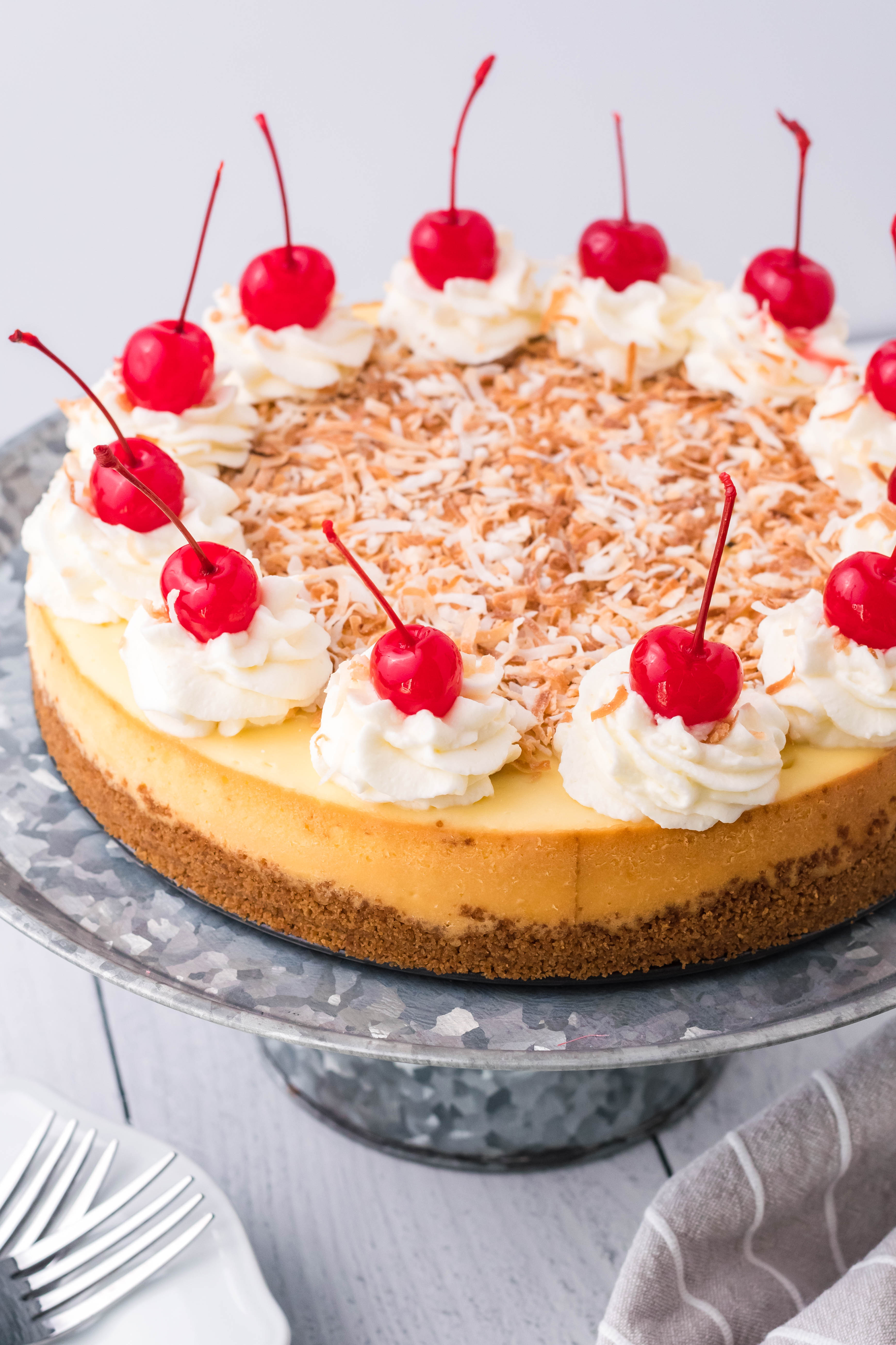 Coconut Cheesecake on a silver cake dish overhead shot