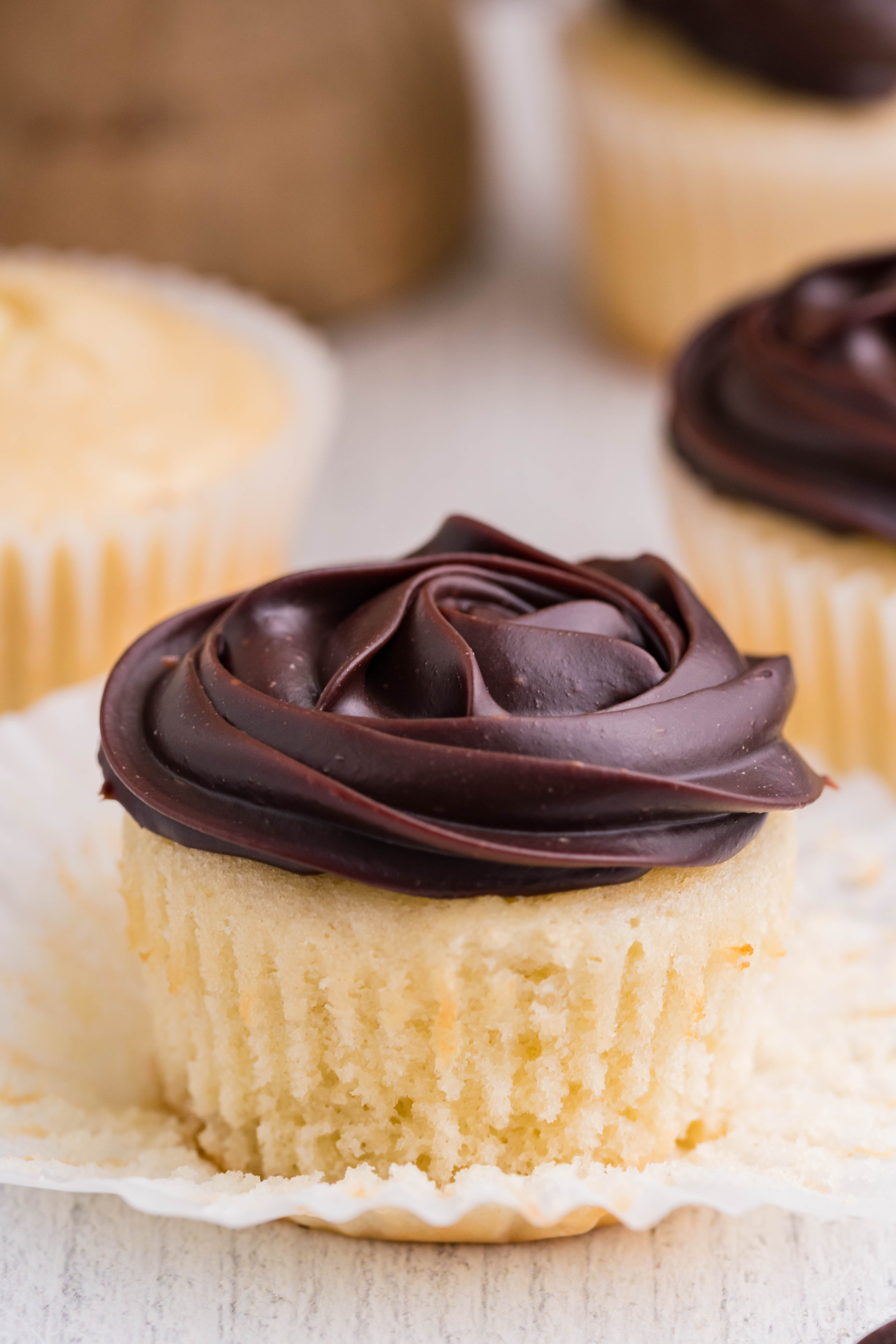 side shot of Boston Cream Cupcakes on a white counter