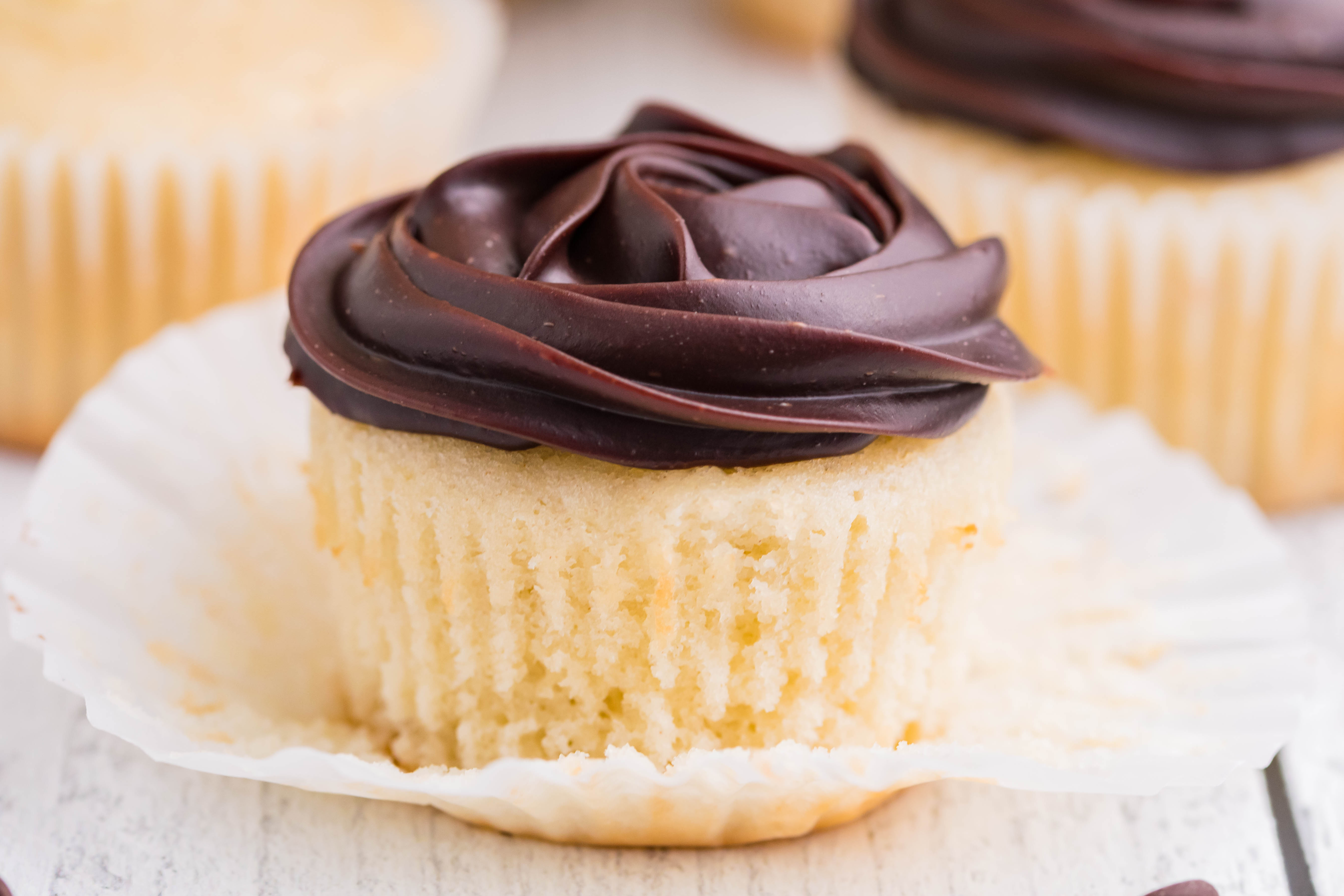 side shot of Boston Cream Cupcakes on a white counter