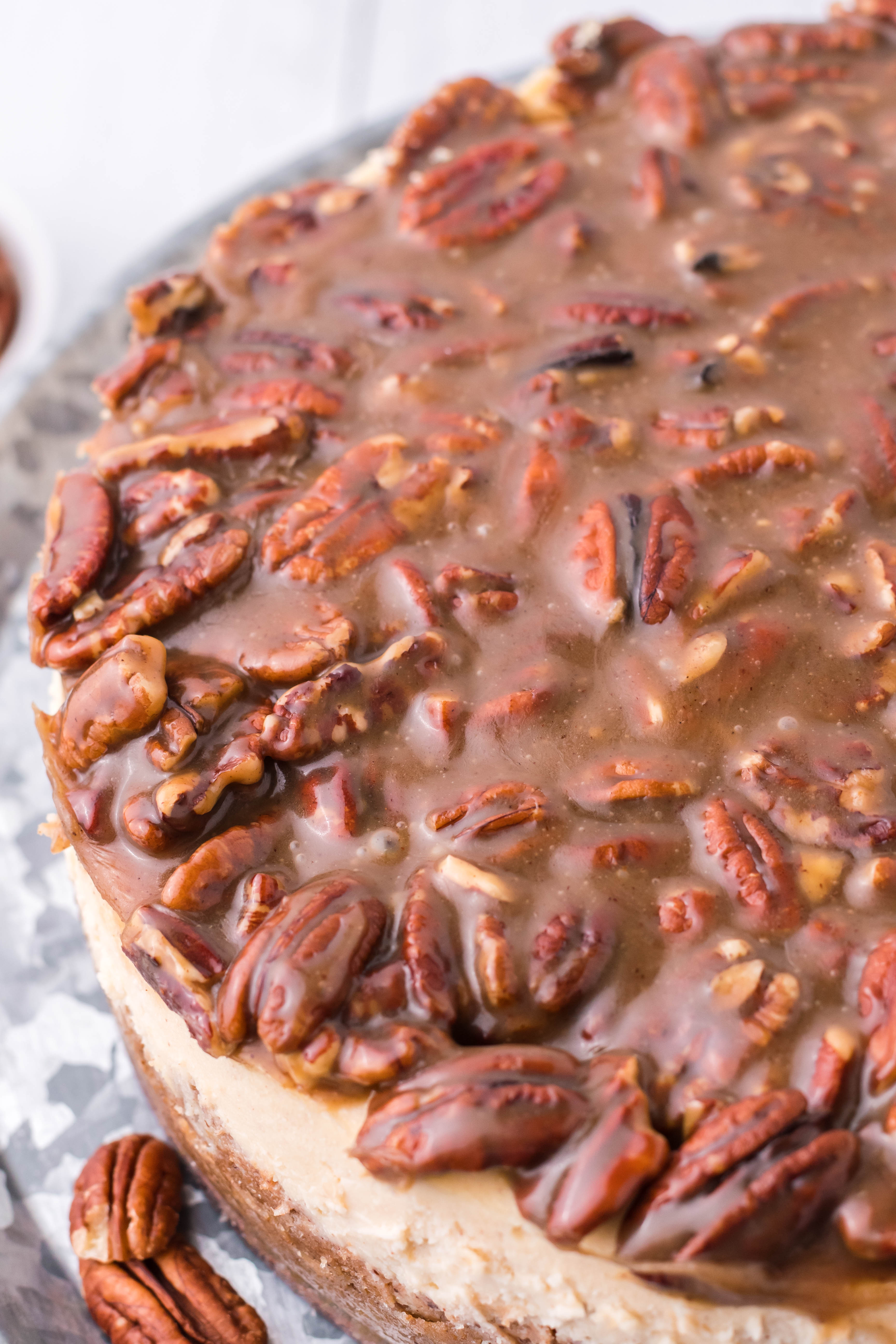 pecan pie Cheesecake on a sliver cake stand overhead shot