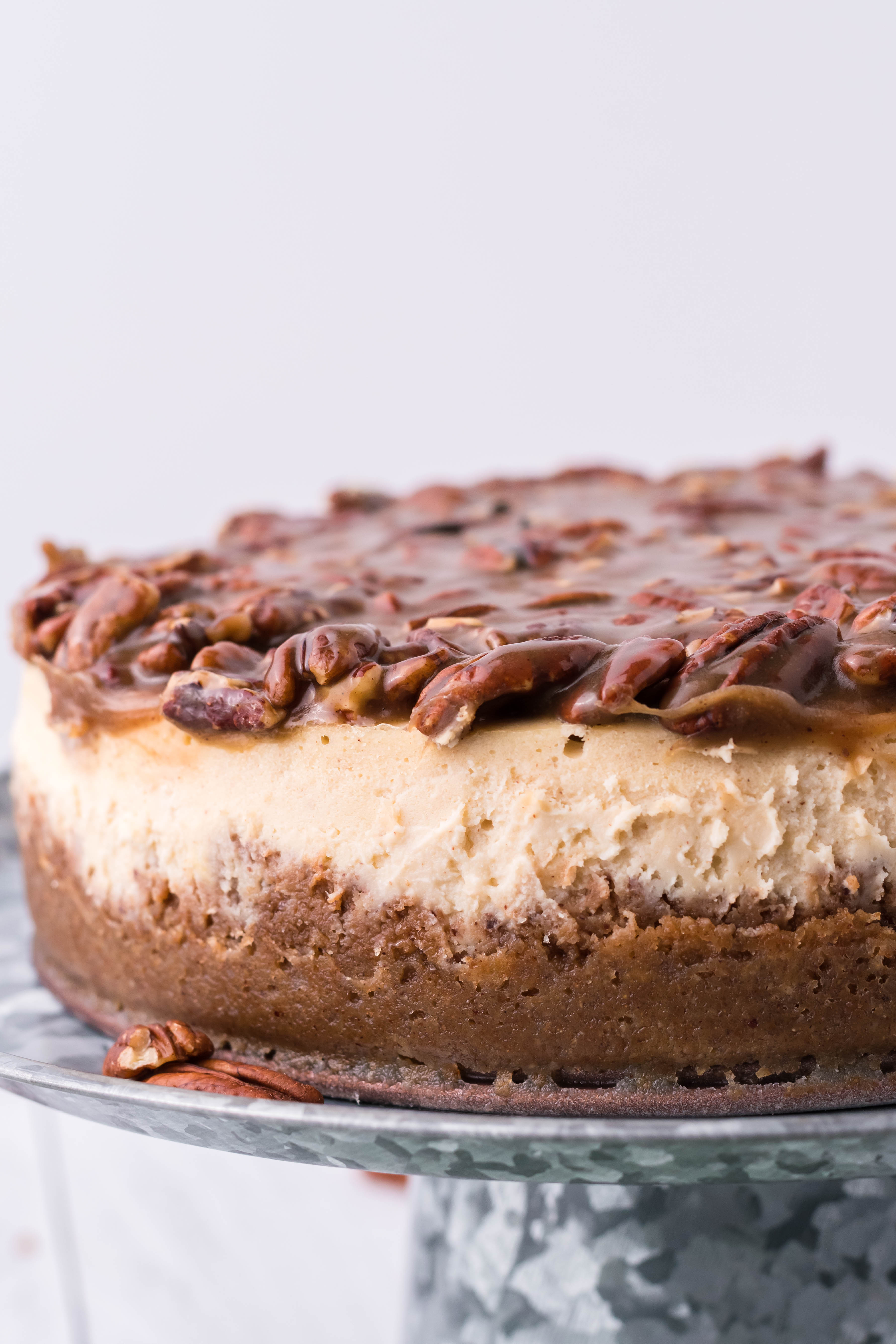 pecan pie Cheesecake on a sliver cake stand from the side