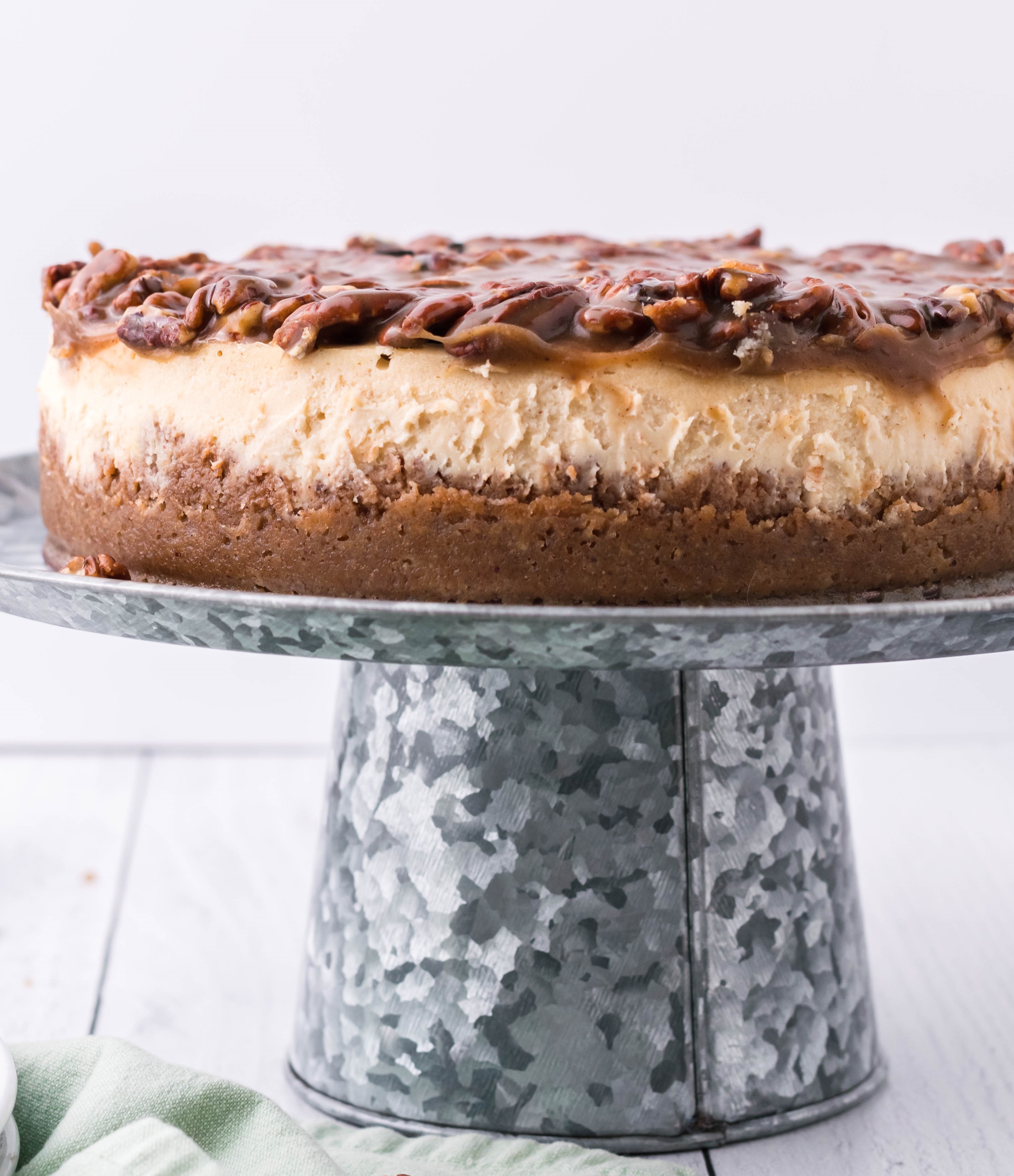 pecan pie Cheesecake on a sliver cake stand side angle