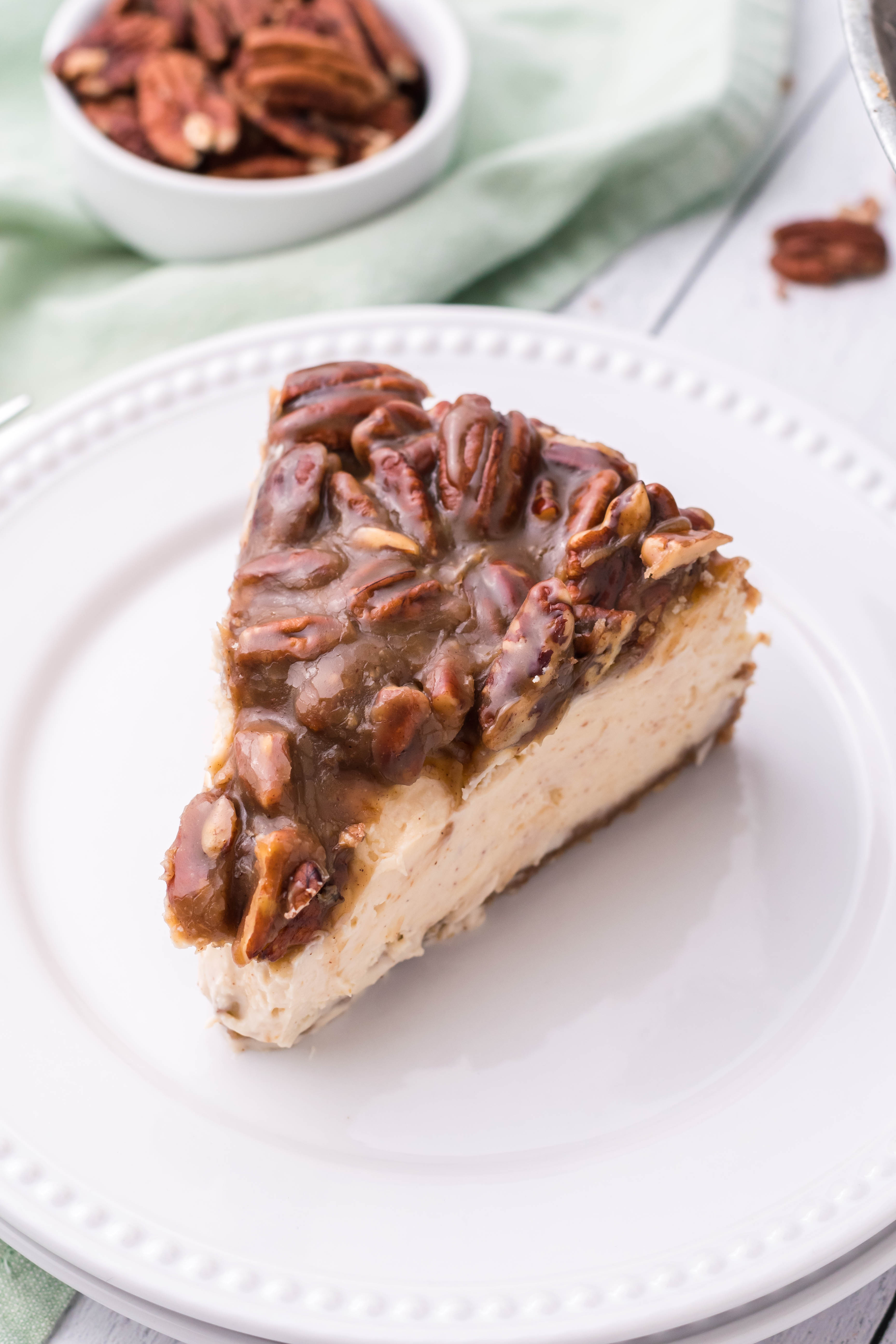 pecan pie Cheesecake slice on a white plate