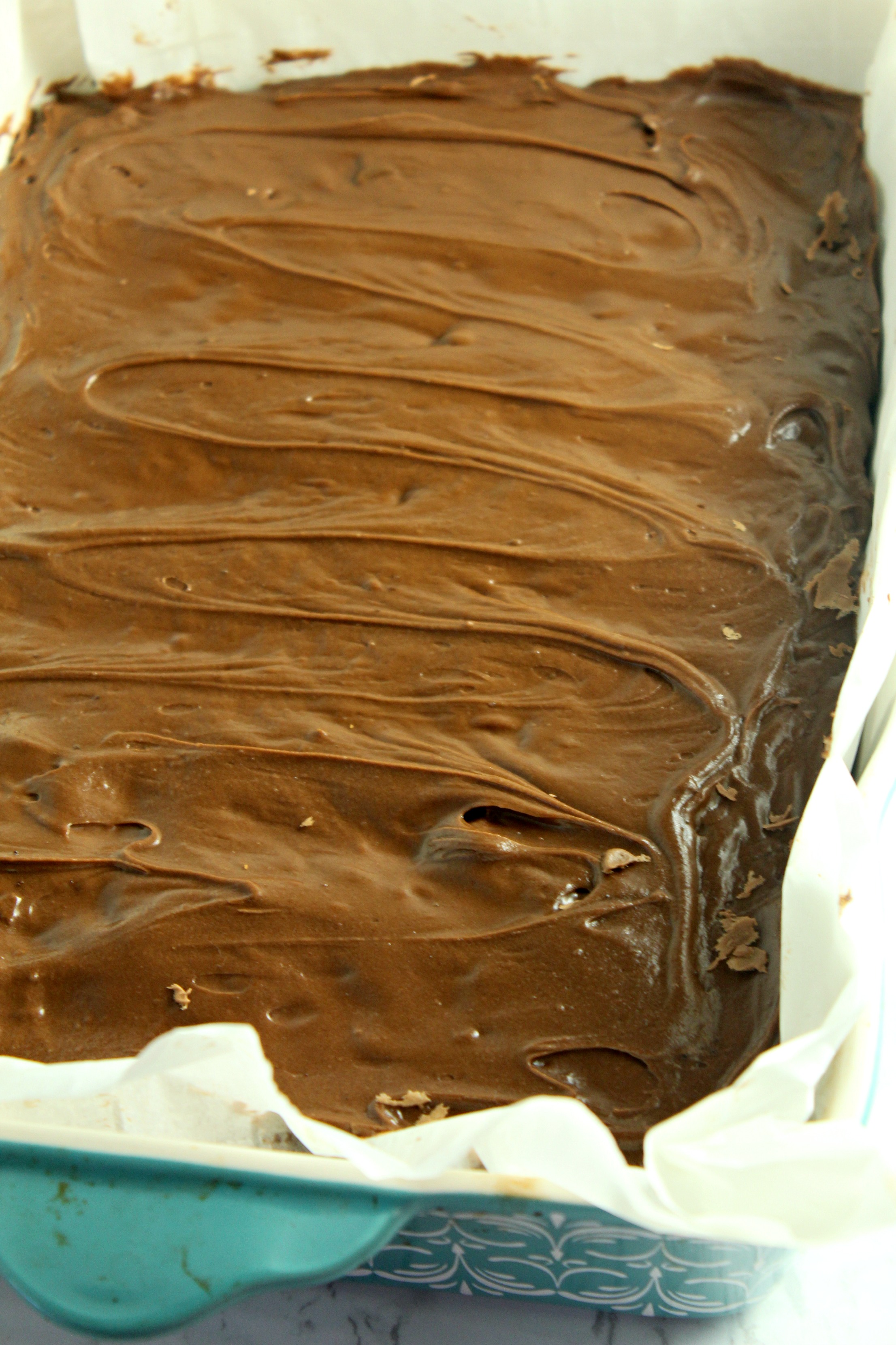 Homemade chocolate frosted lunch lady Brownies in a baking dish uncut