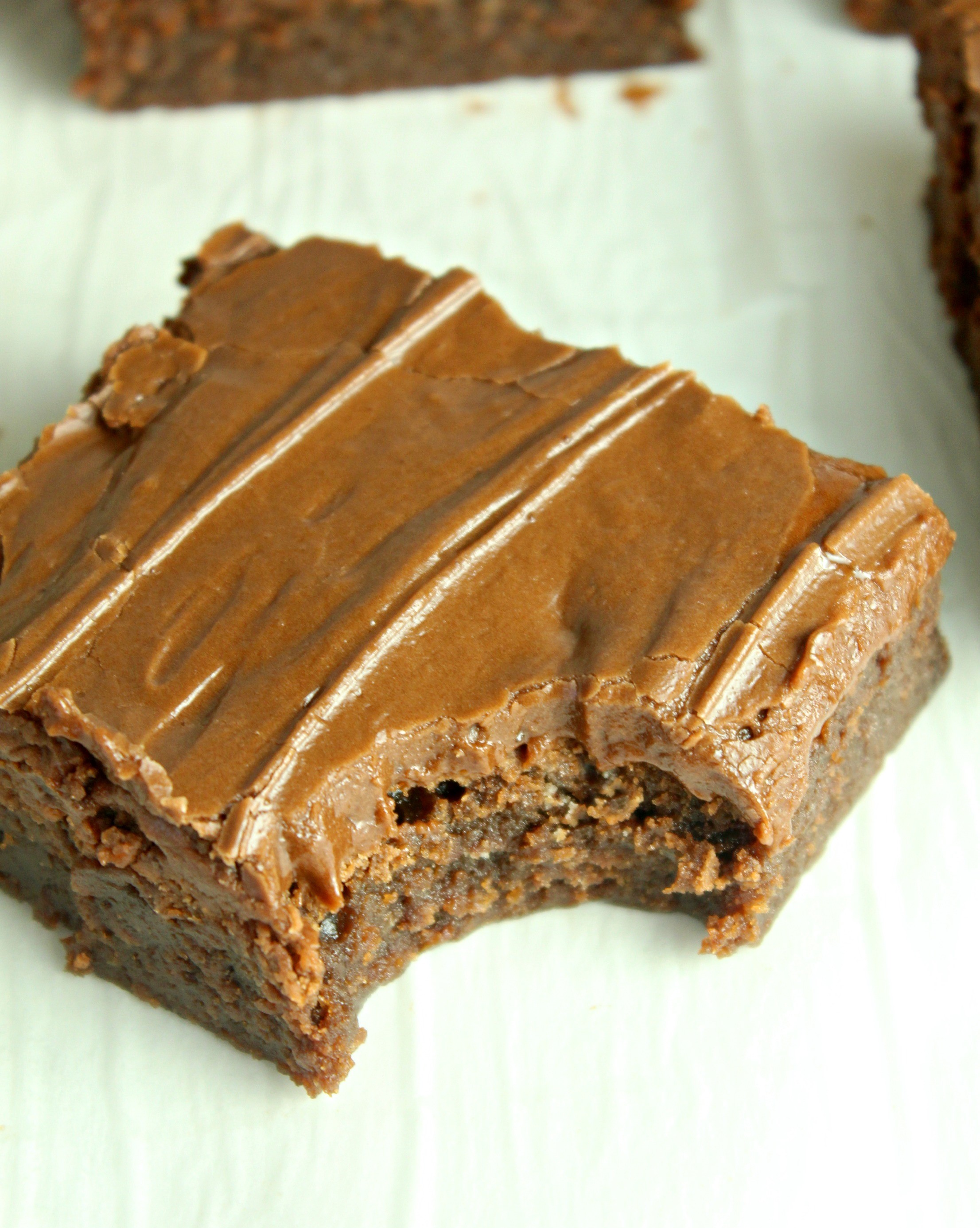 Homemade chocolate frosted lunch lady Brownies with a bite taken out of a square