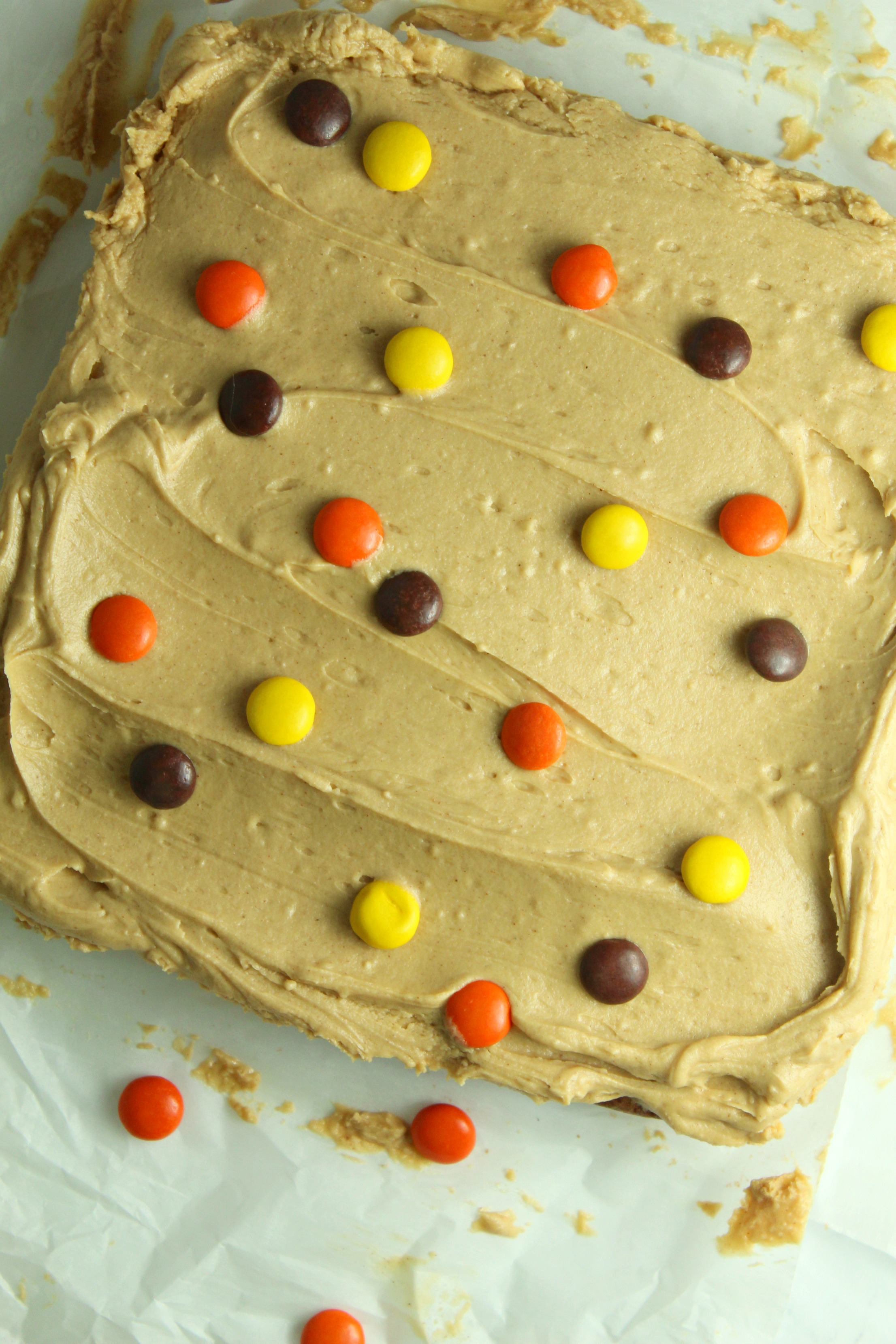 Peanut Butter Bars topped with peanut butter frosting & reeses pieces uncut