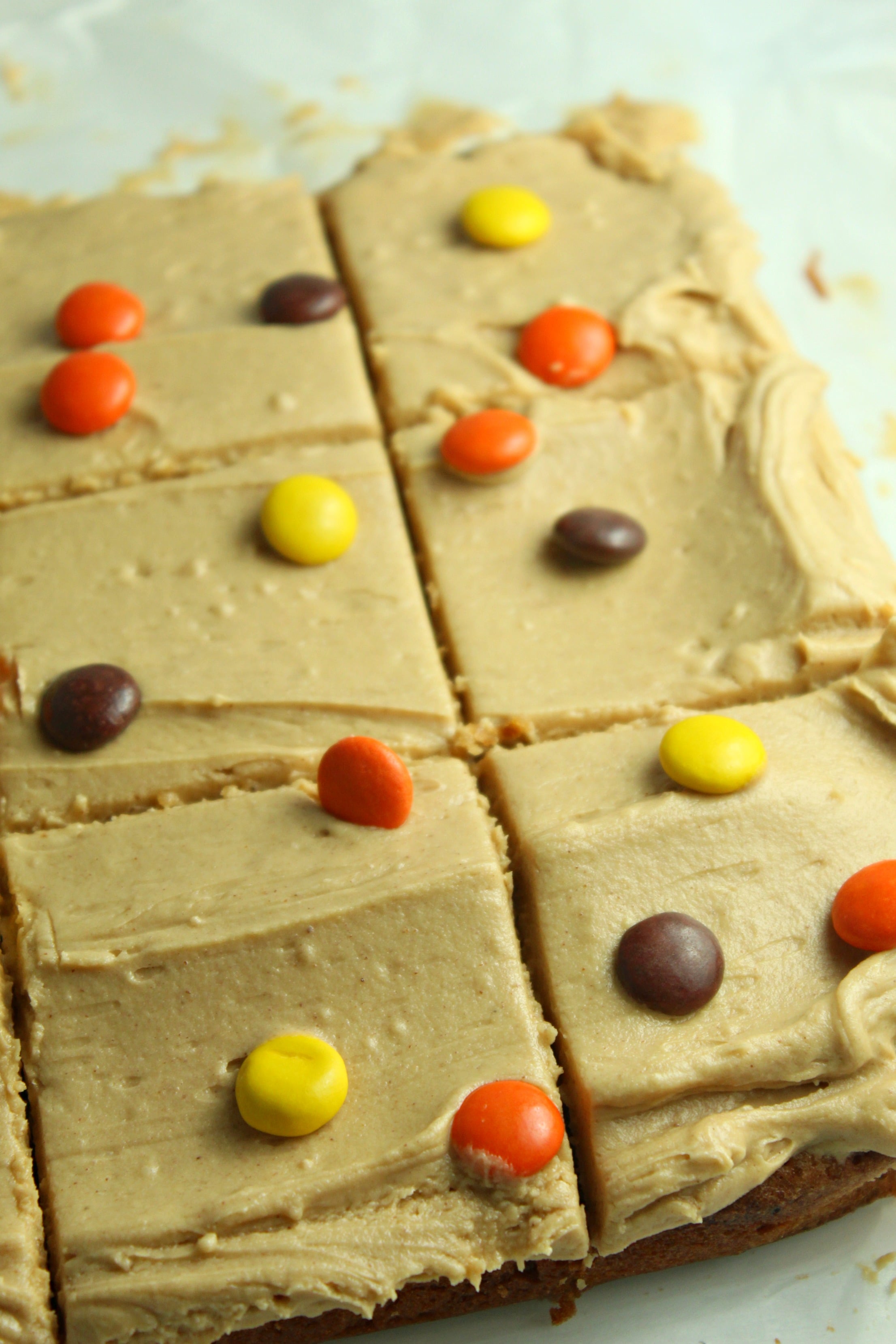 Peanut Butter Bars topped with peanut butter frosting & reeses pieces