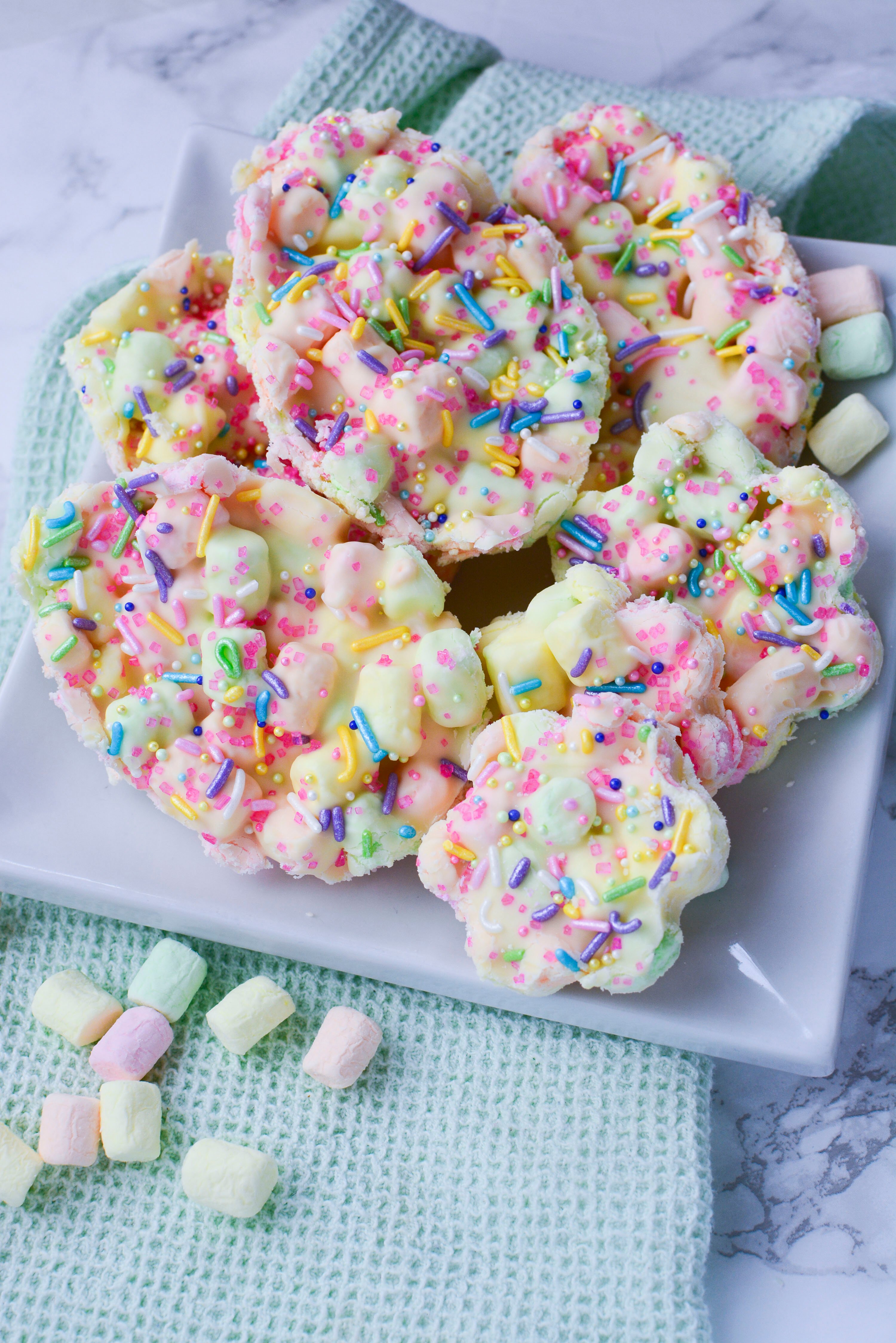 Easter Marshmallow treats with pink, green and yellow mini marshmallows cut into the shape of eggs and flowers