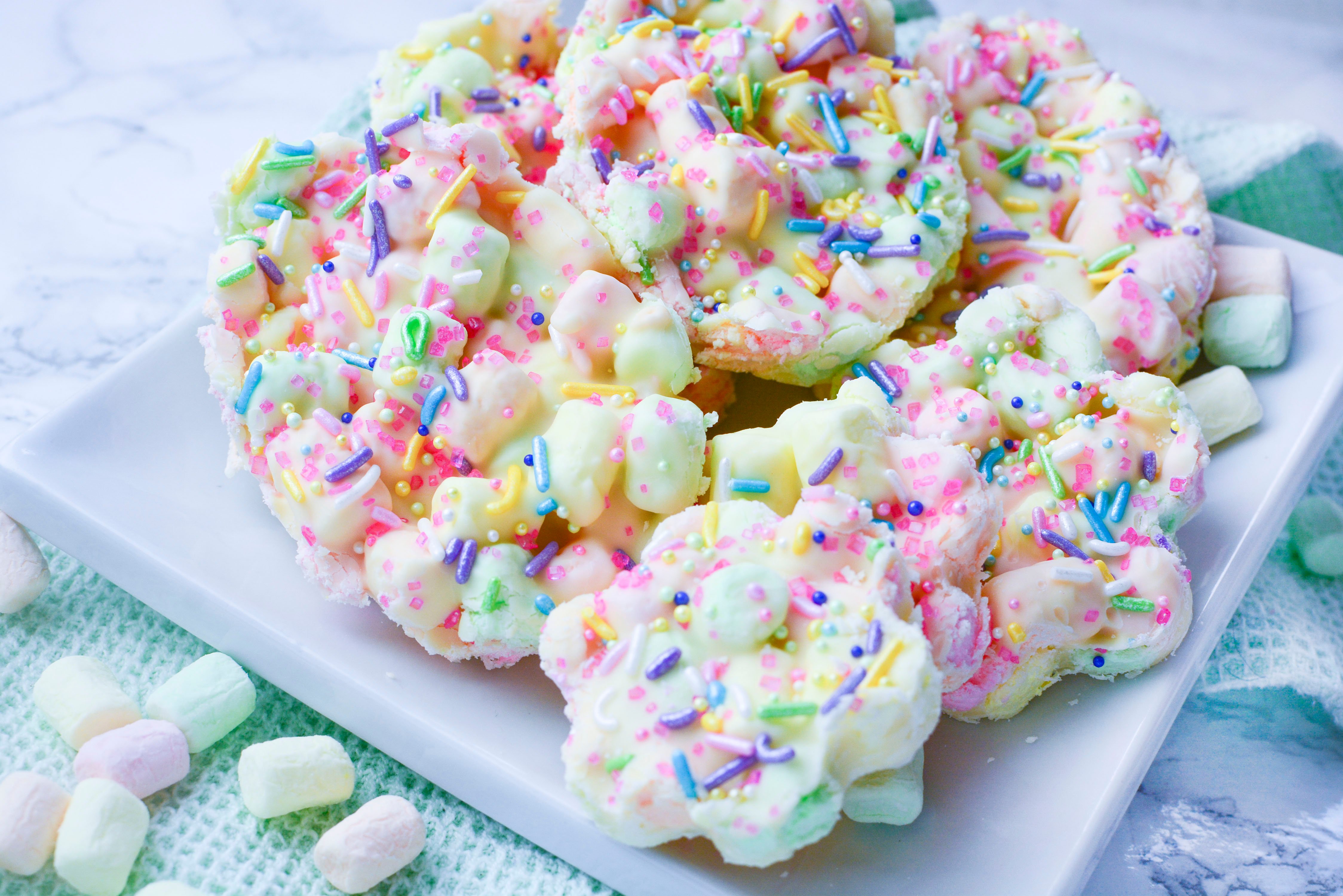 Easter Marshmallow treats with pink, green and yellow mini marshmallows cut into the shape of flowers