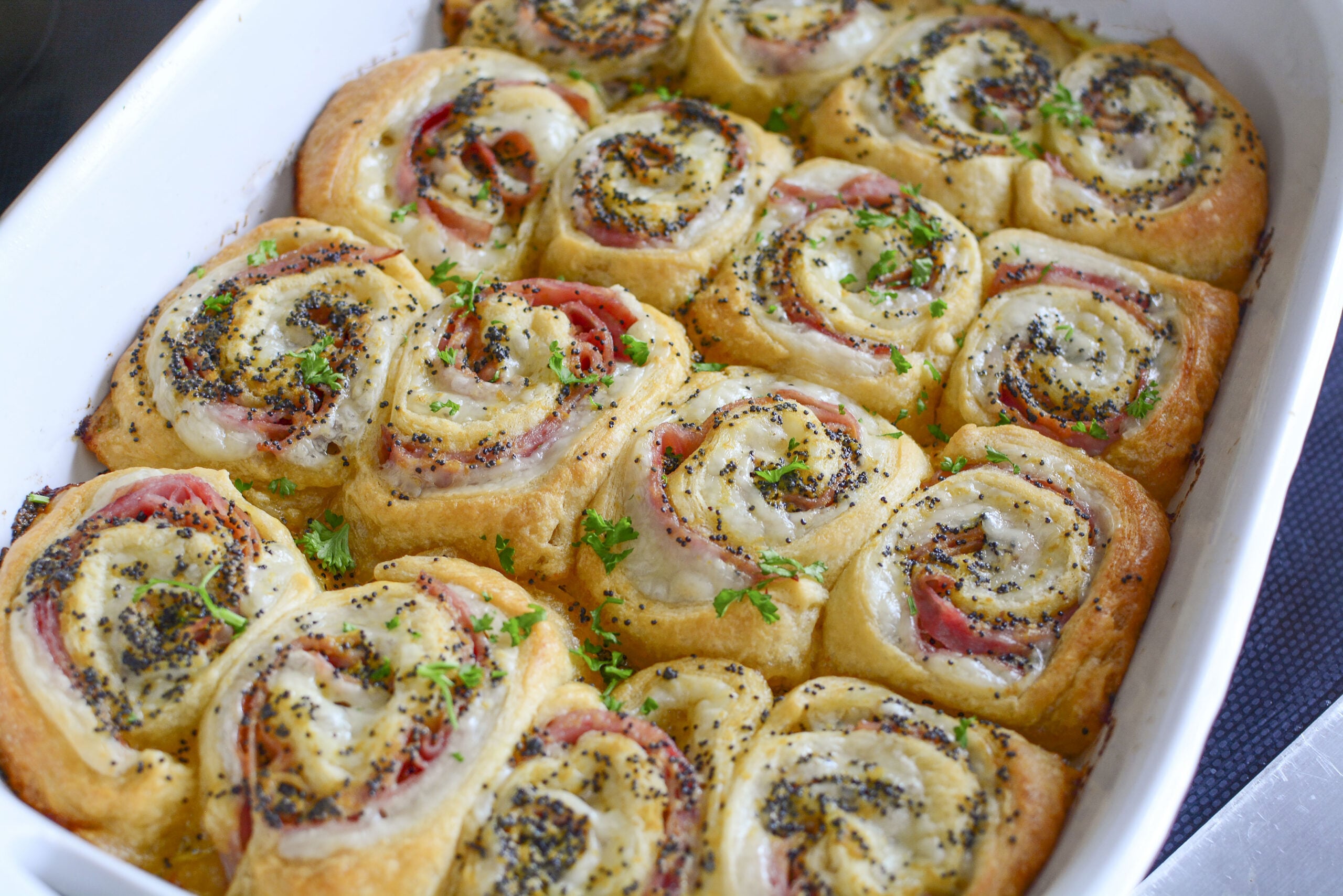 Ham and Cheese Pinwheels in a white baking dish