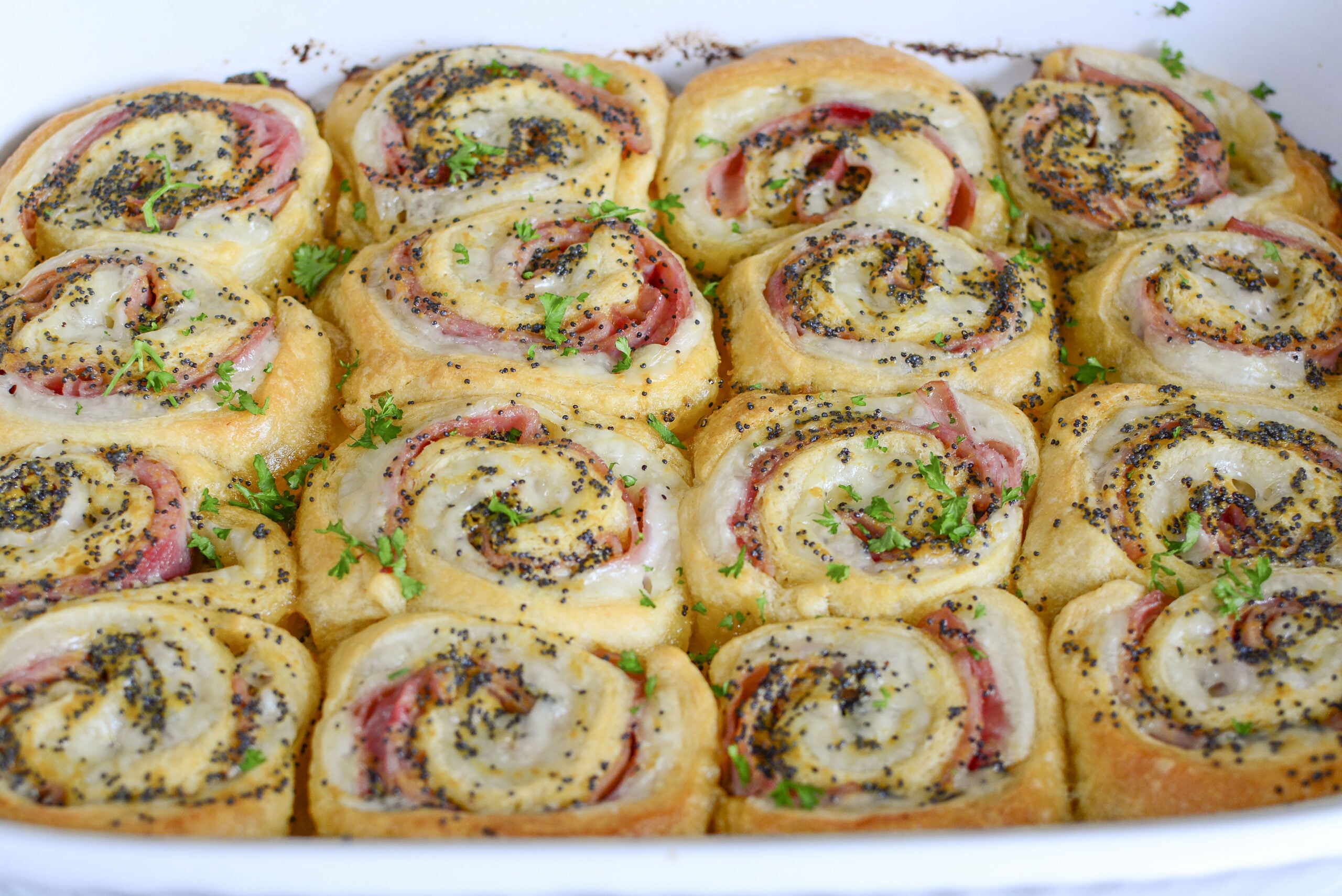 Ham and Cheese Pinwheels in a white baking dish