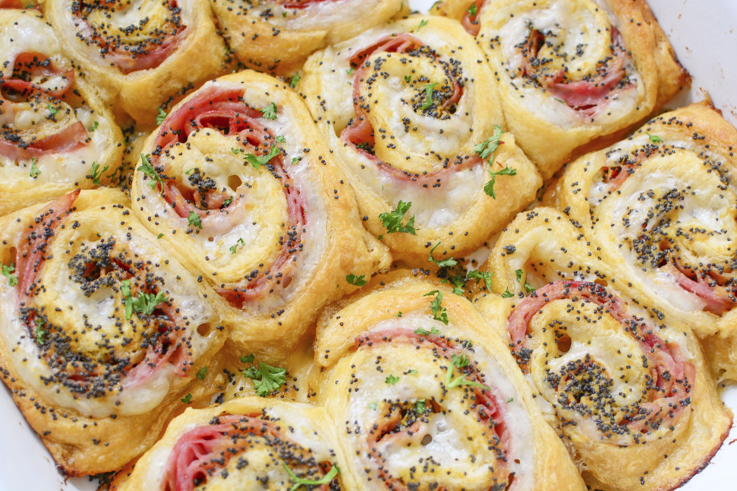 Ham and Cheese Pinwheels in a white baking dish
