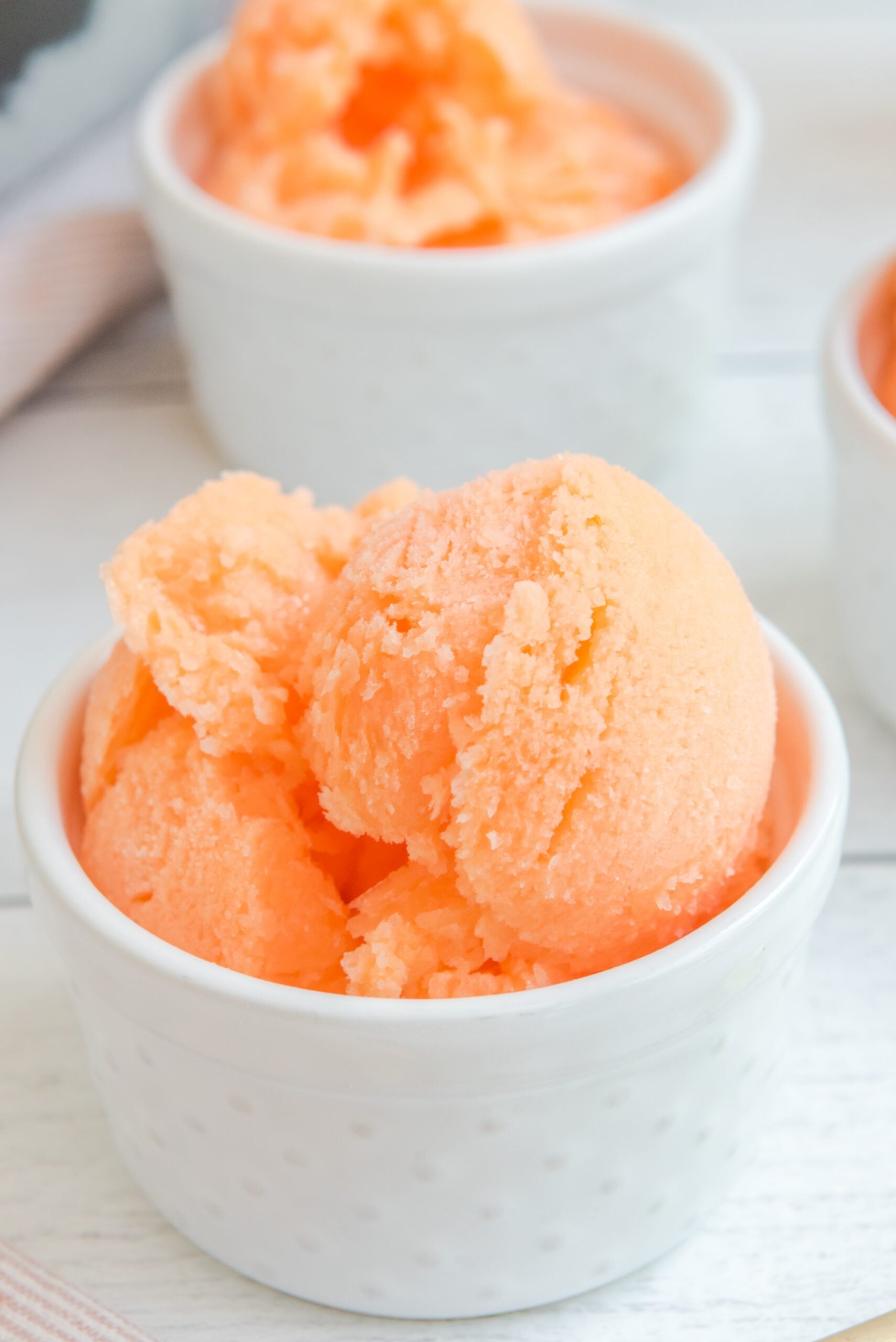 Orange Crush Sherbet in a white bowl close up to show texture